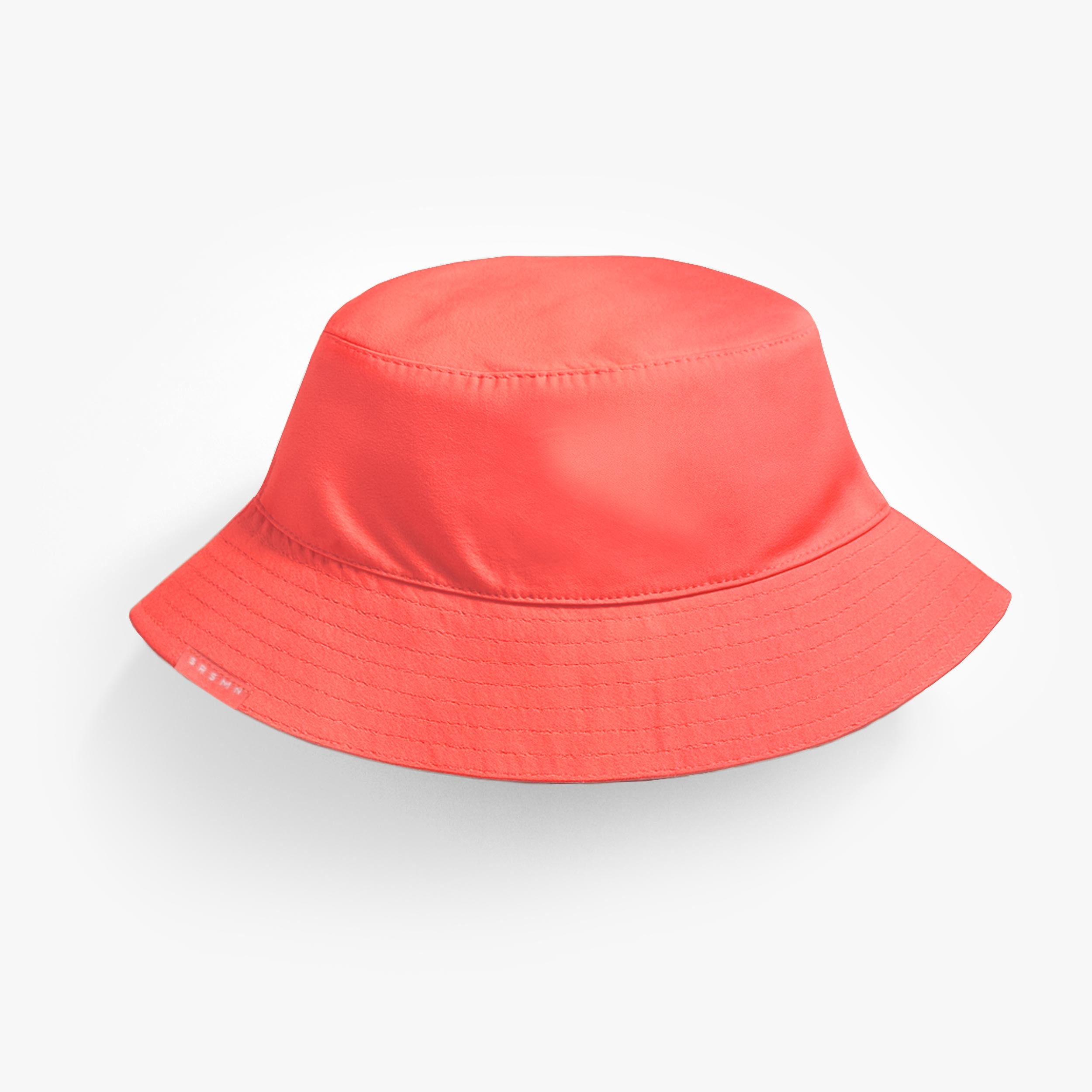 Revers du chapeau de soleil réversible rose corail et crème, enfant