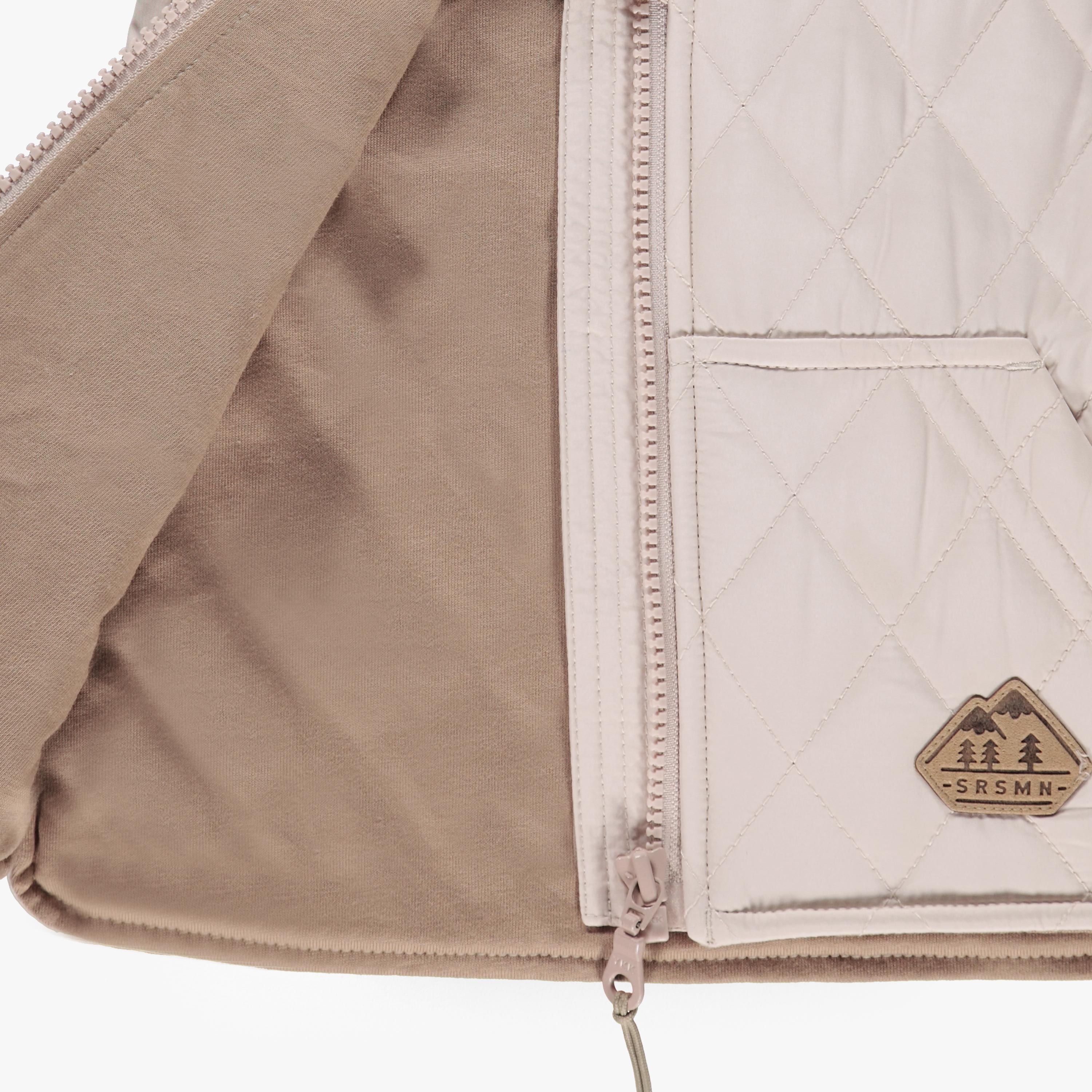 Beige sleeveless vest with a diamond quilted pattern, baby