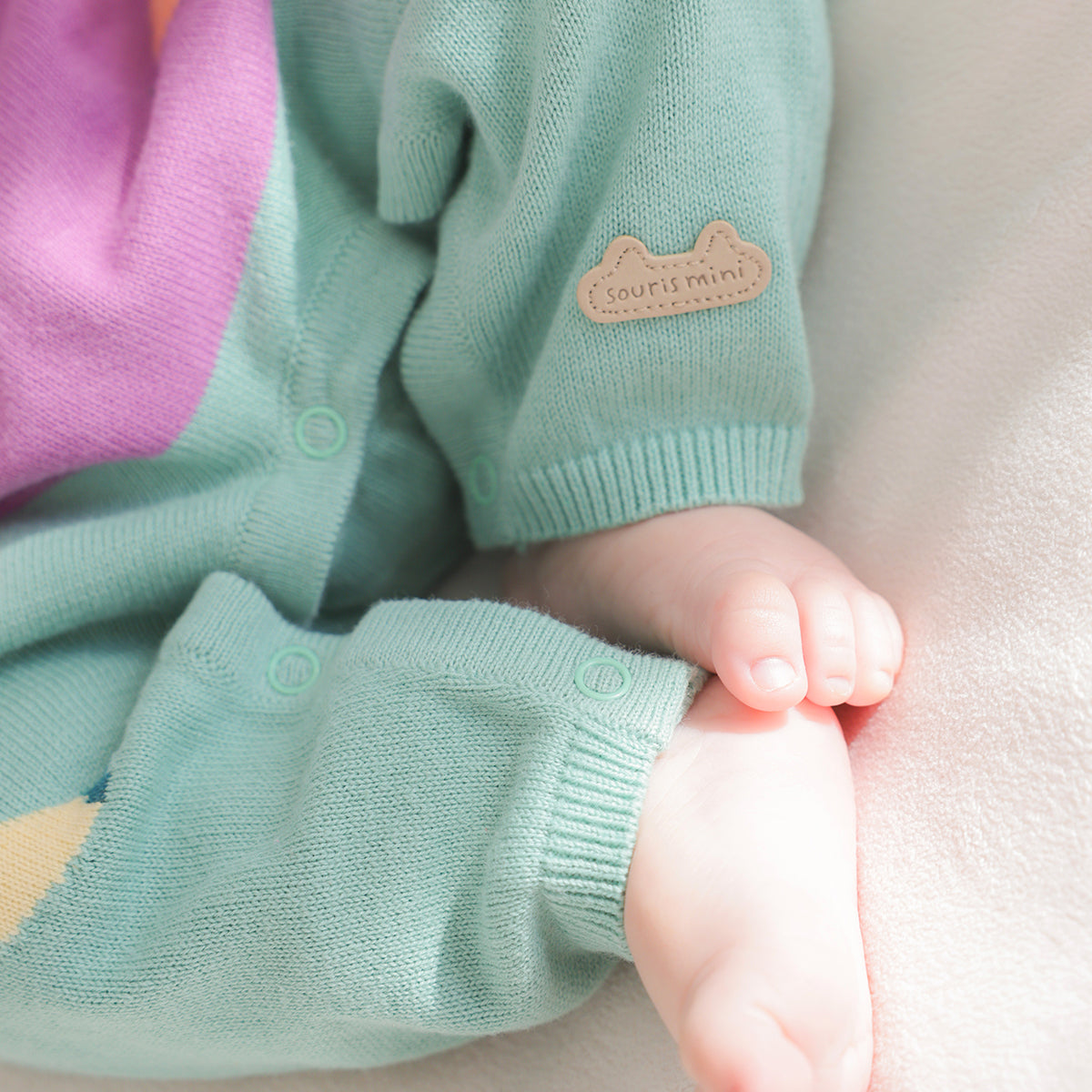 Cream, purple and turquoise knit jumpsuit with fruity patterns, newborn