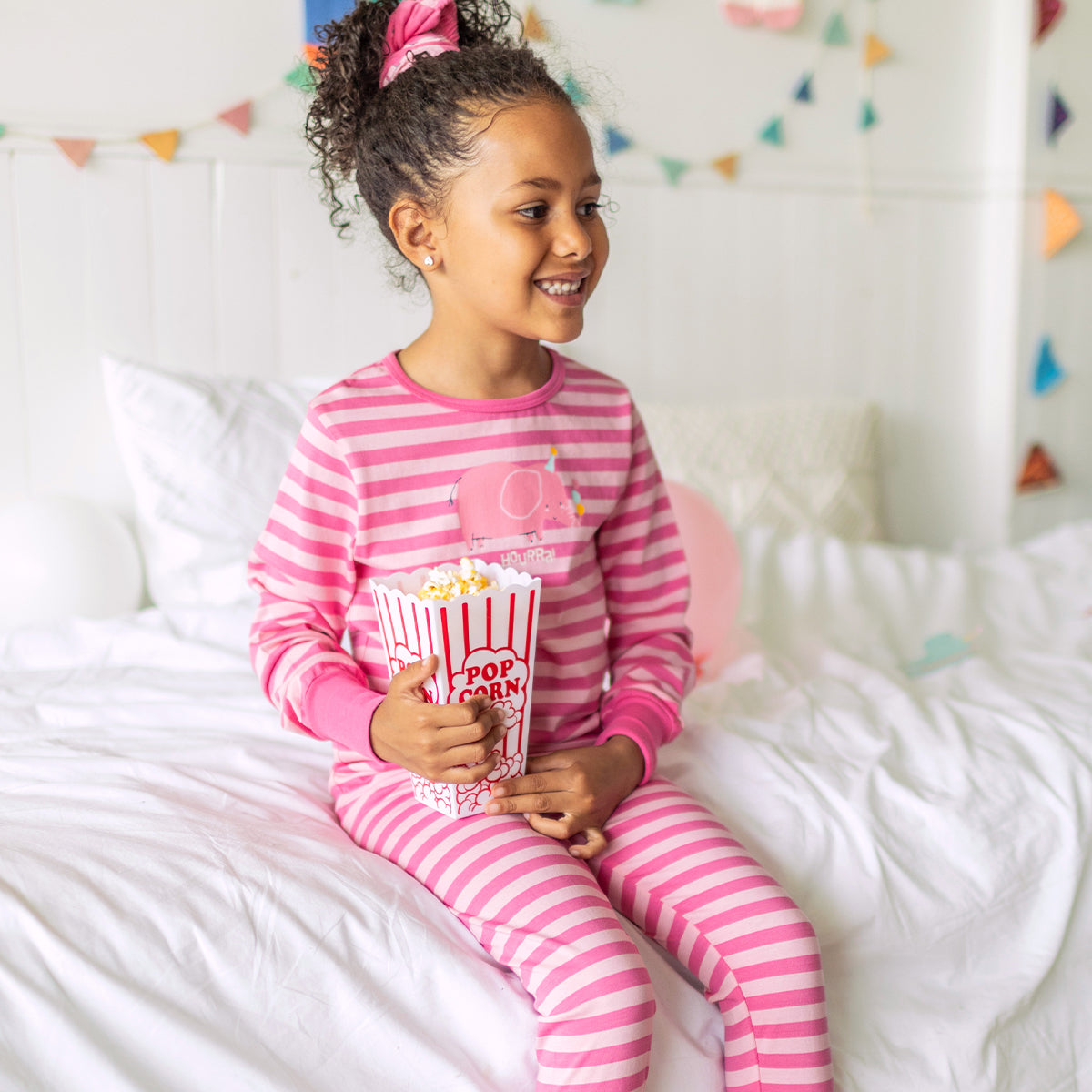 Photo d'un enfant portant du pyjama deux pièces rose à rayures, enfant