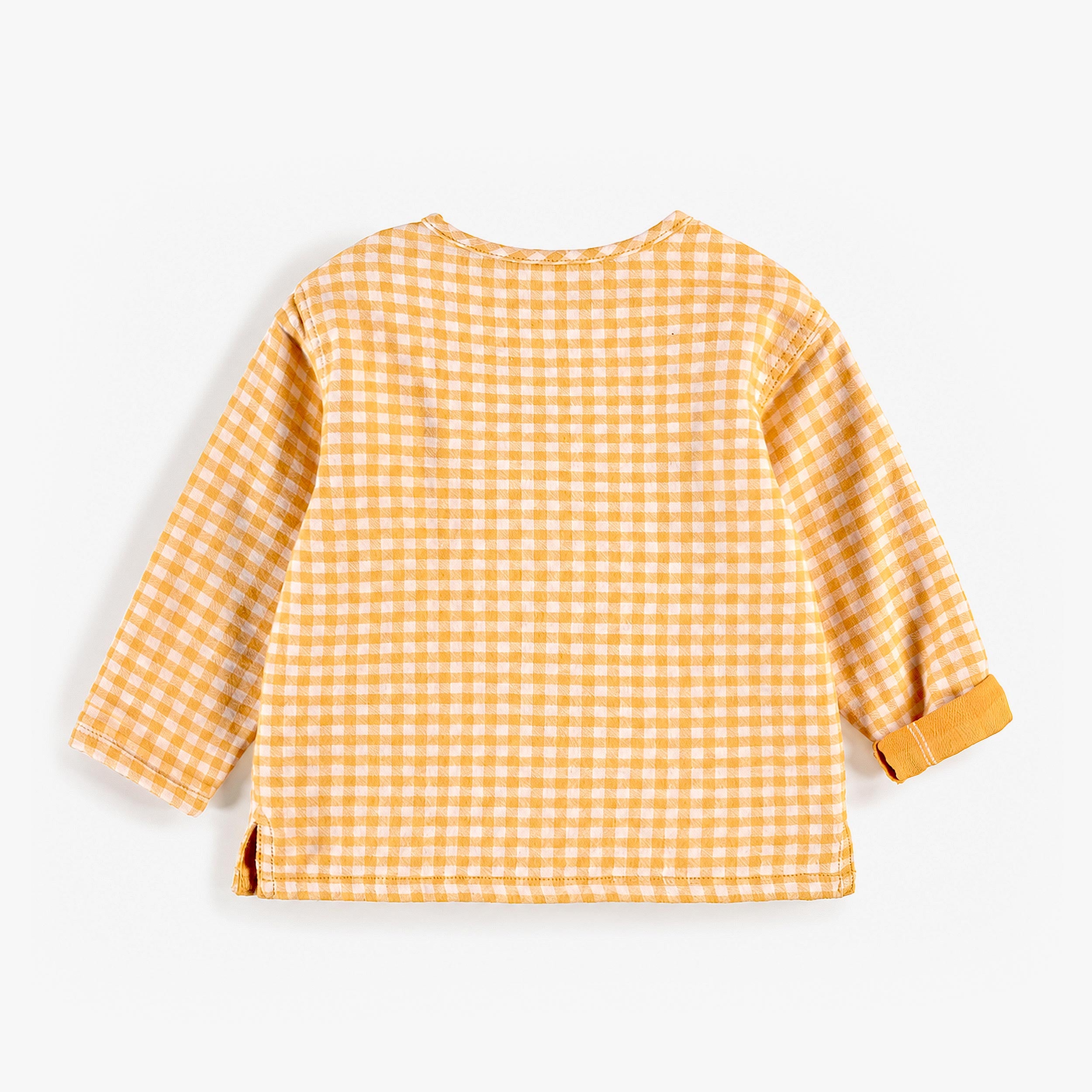 Chemise à carreaux jaune, naissance