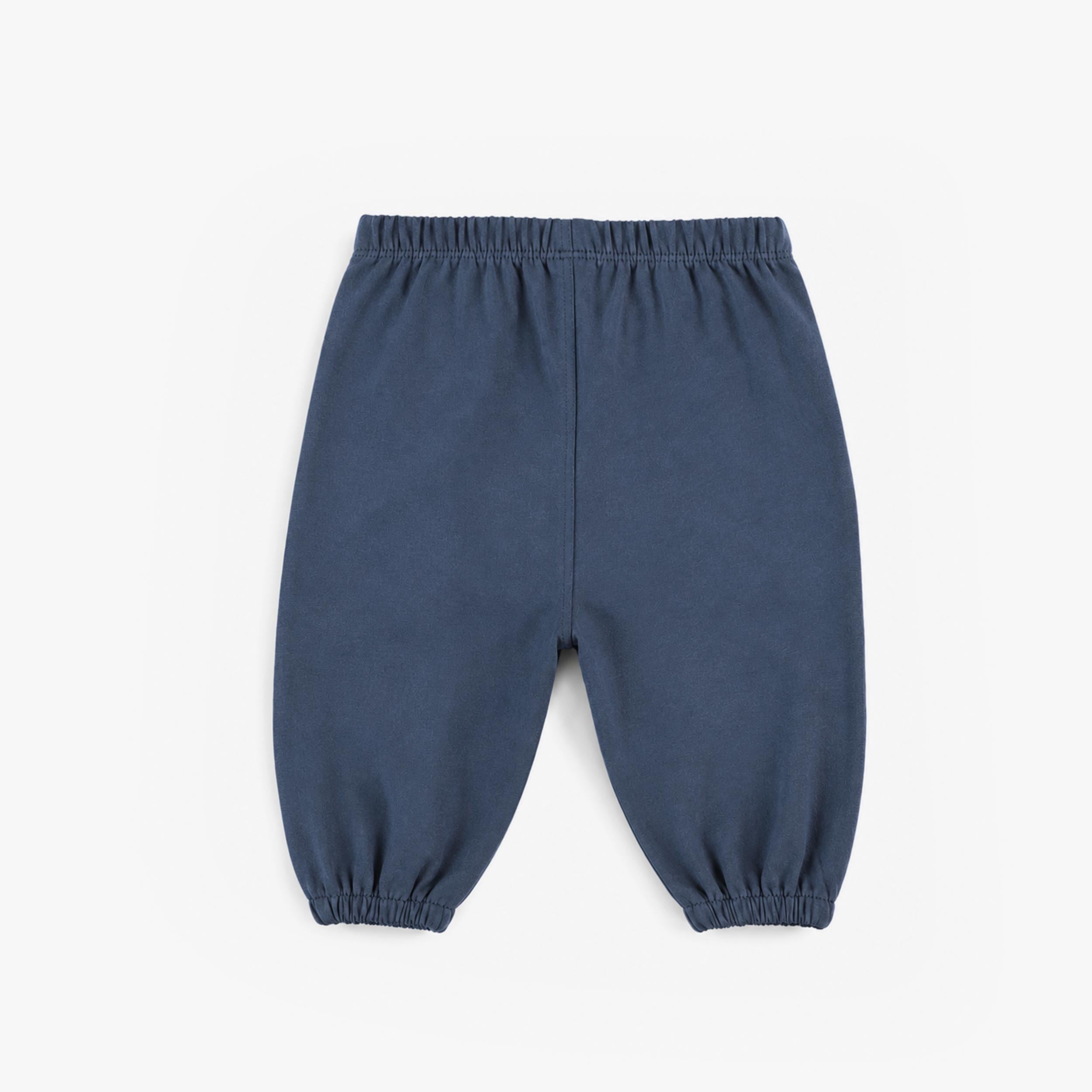 Pantalon bleu en coton français, naissance