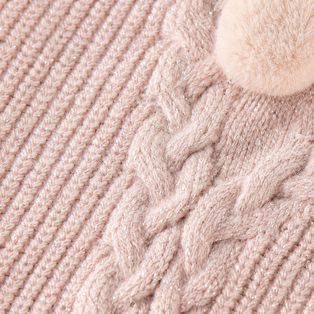 Pink knit sweater with pom-poms and cable details, child