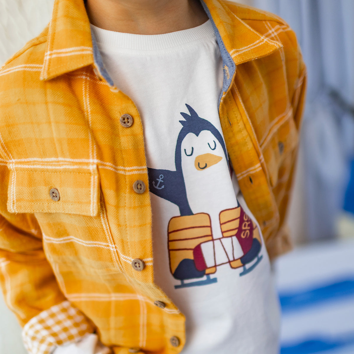 Cream-colored T-shirt with a hockey design, child