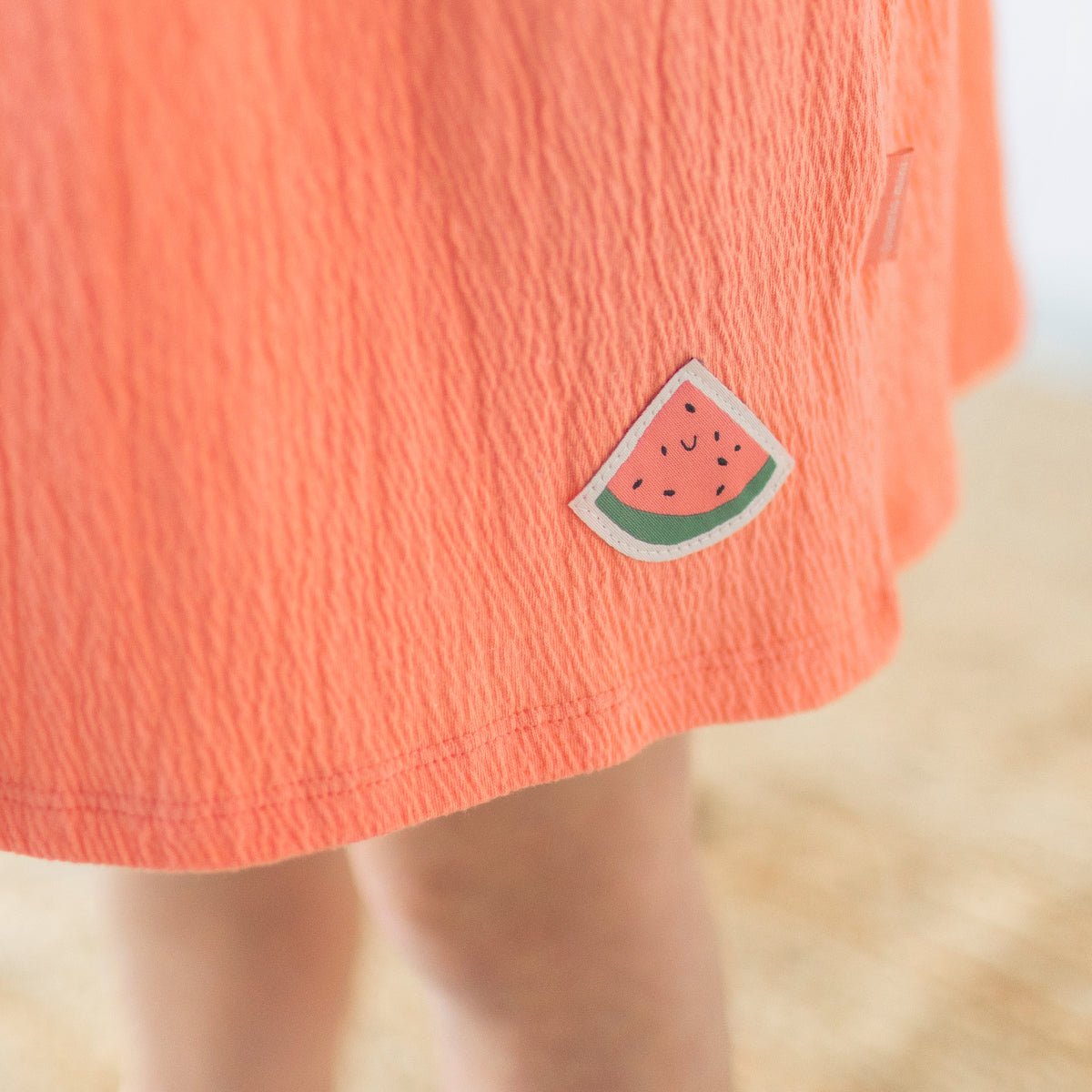 Zoom de l'écusson à motif de melon d'eau de la robe rose avec volants, enfant