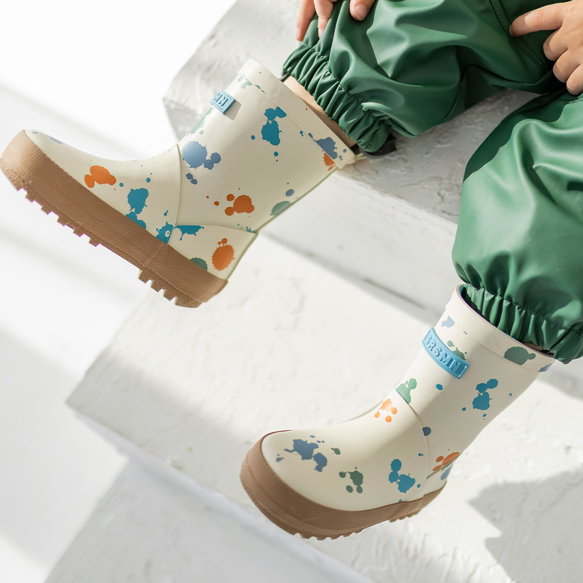 Cream and brown waterproof rain boots with paint splatter all over print