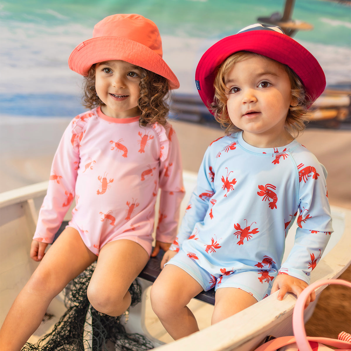 Light blue one-piece swimsuit with lobster patterns, baby