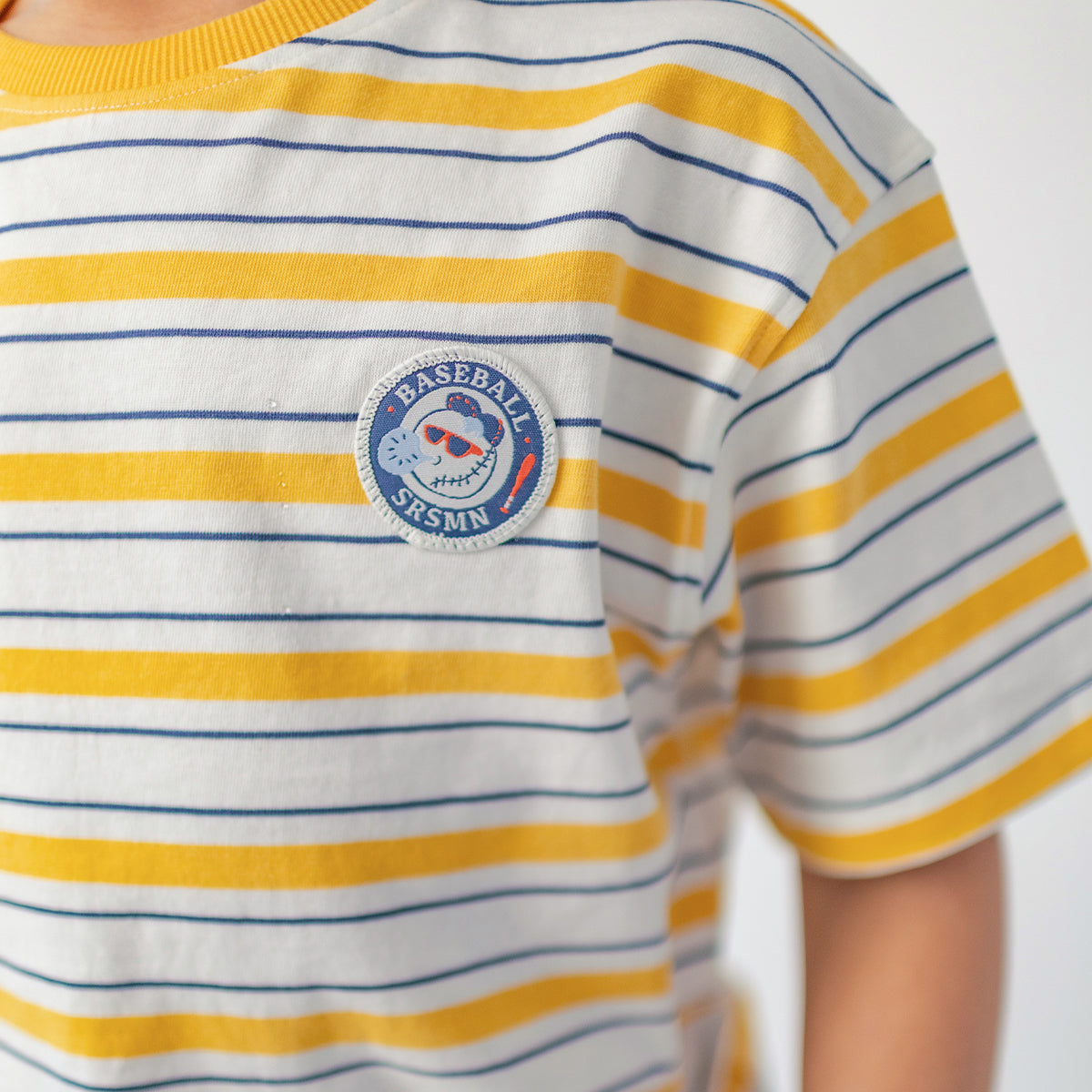 White T-shirt with yellow and navy blue stripes, child