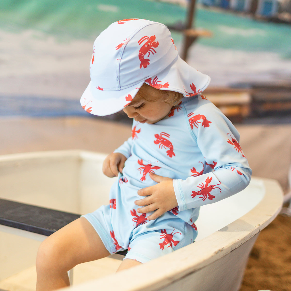 Light blue one-piece swimsuit with lobster patterns, baby