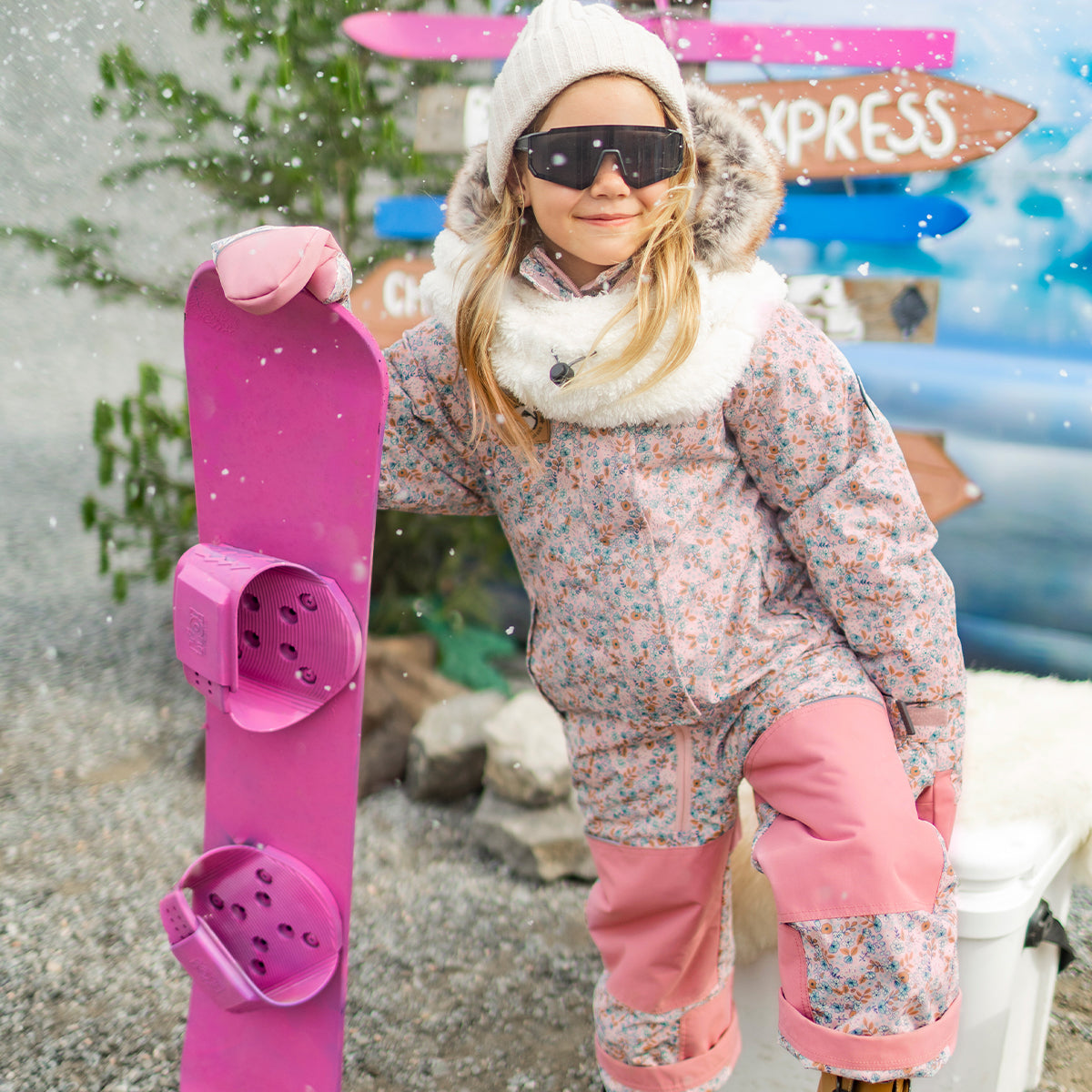 Photo d'un enfant portant l'habit de neige une pièce rose avec fleurs, enfant