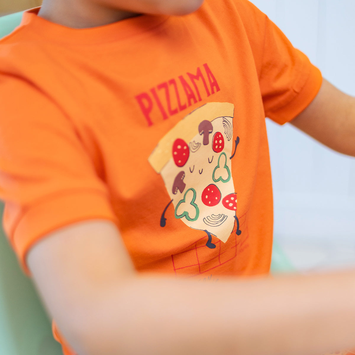 Orange two-piece pajamas with pizza patterns, child