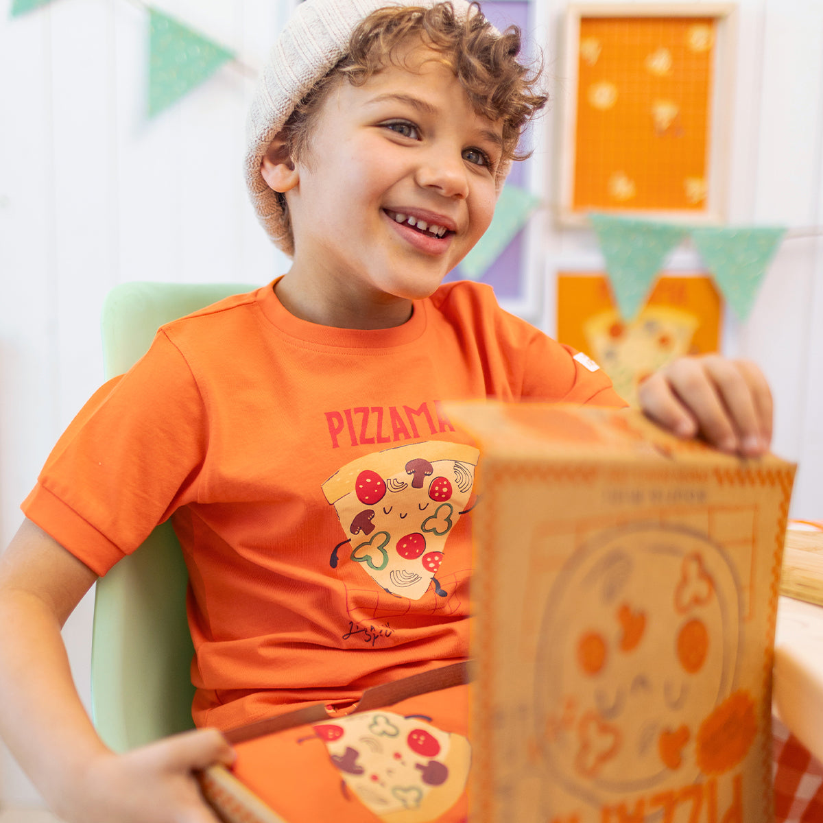Orange two-piece pajamas with pizza patterns, child