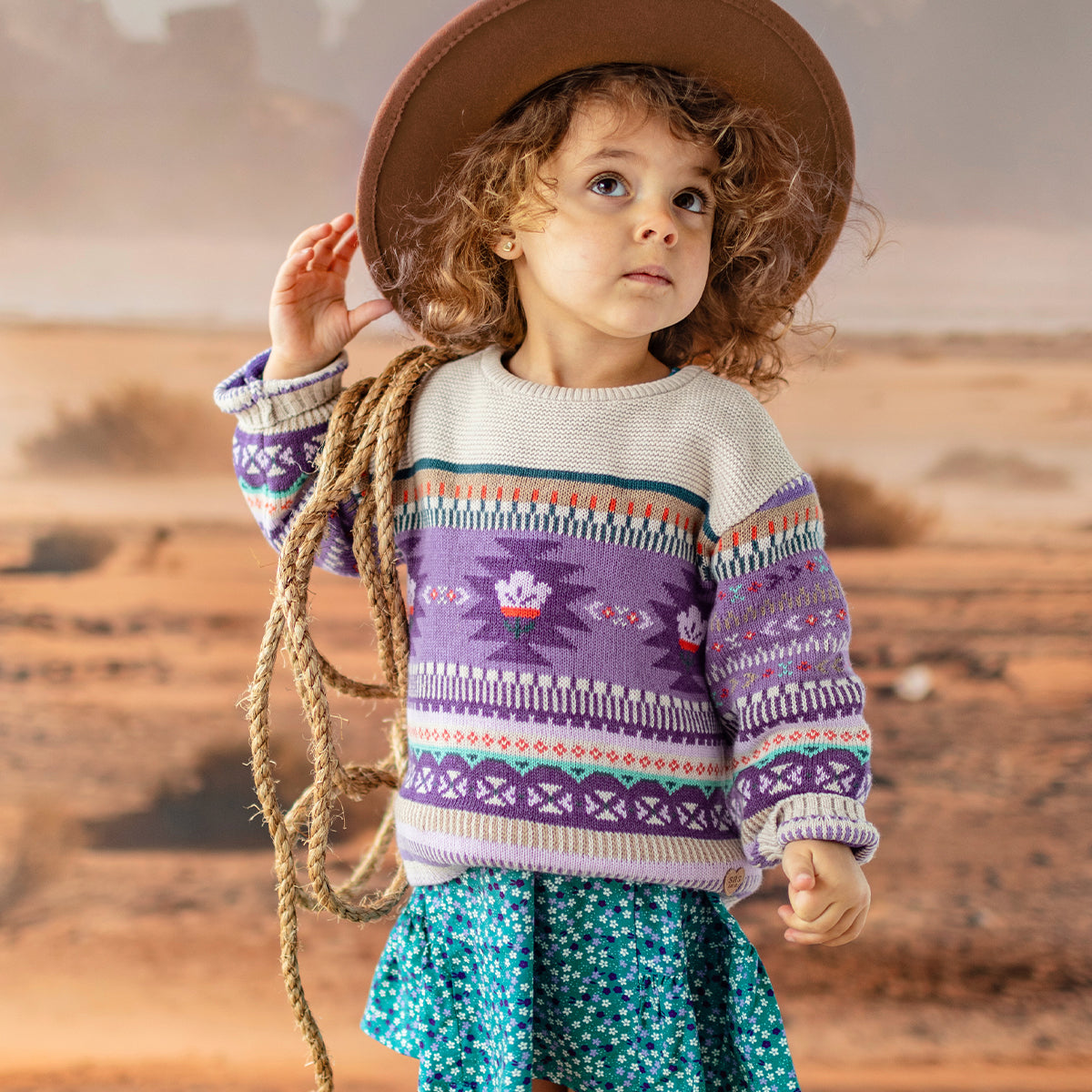 Photo d'un enfant portant le chandail beige et mauve en tricot, bébé