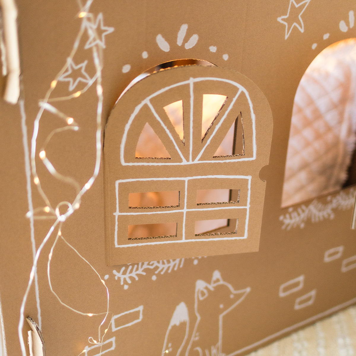 Holiday cardboard playhouse, child