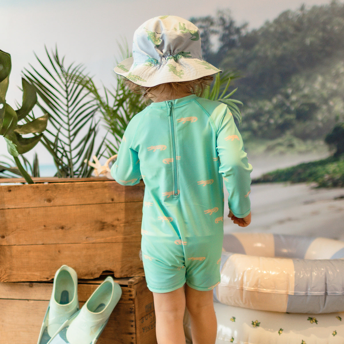 Turquoise one-piece swimsuit with crocodile patterns, baby