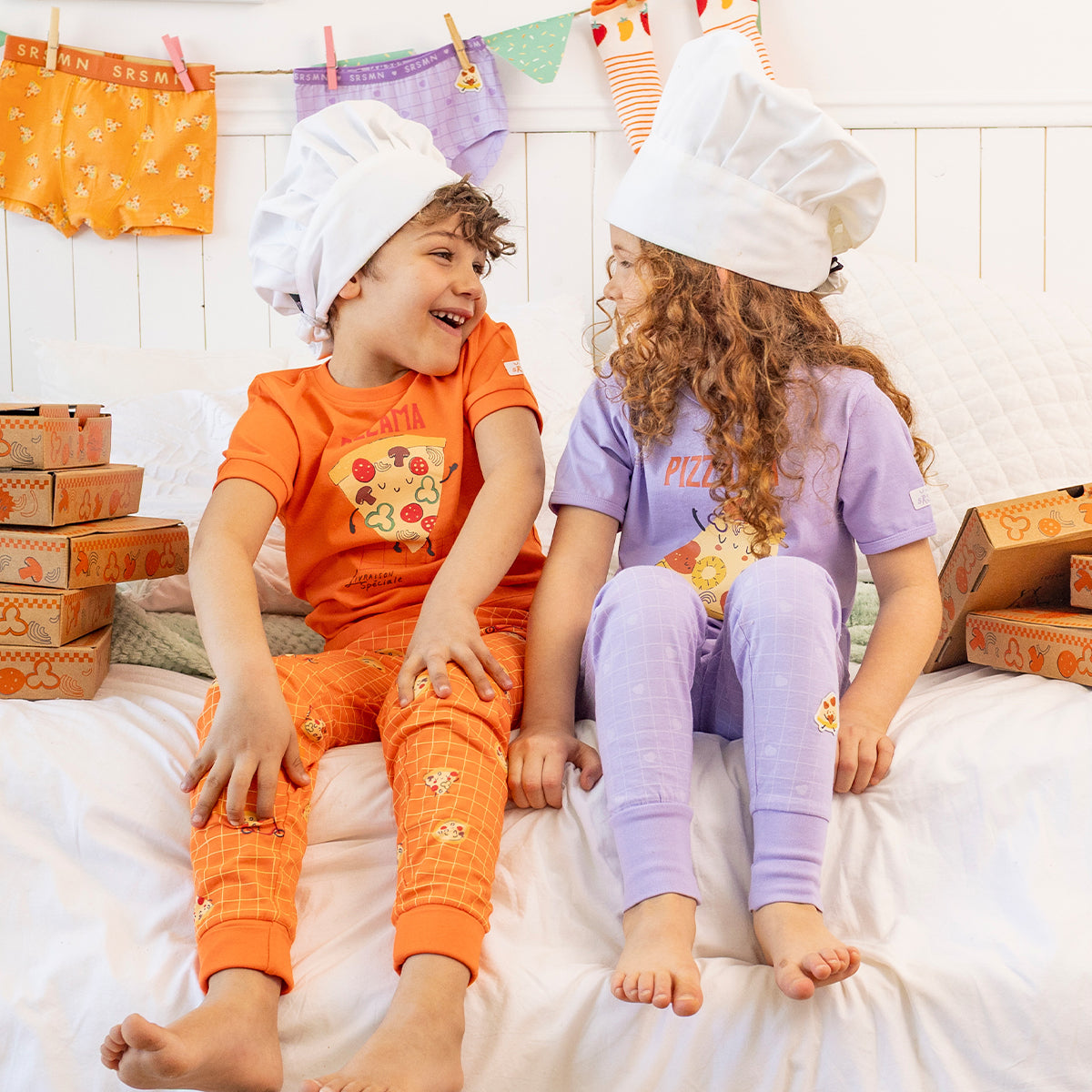 Two-piece purple pajamas with pizza patterns, child
