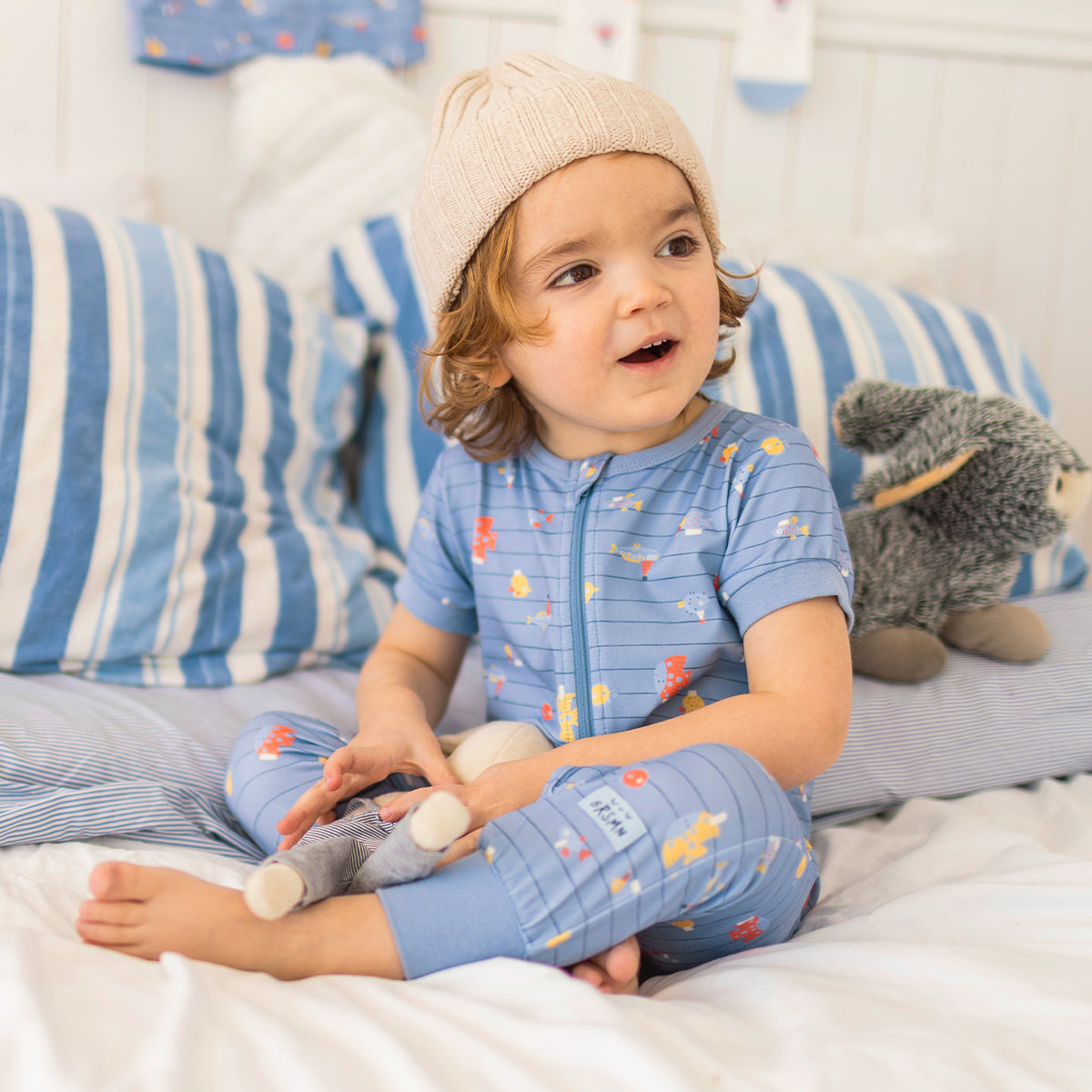Blue one-piece pajamas with stripes and fish patterns, baby