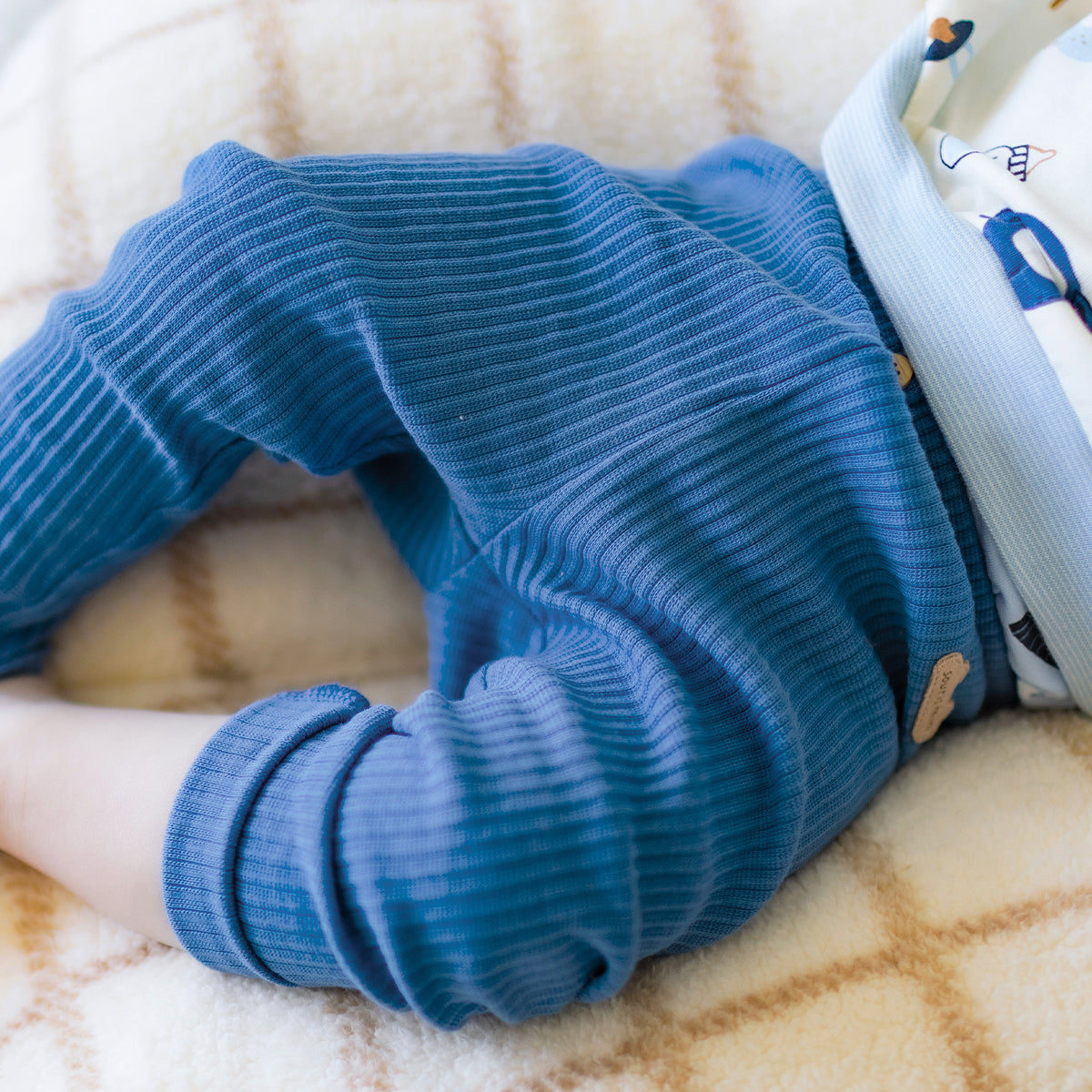 Photo d'un bébé portant le legging bleu en tricot côtelé, naissance