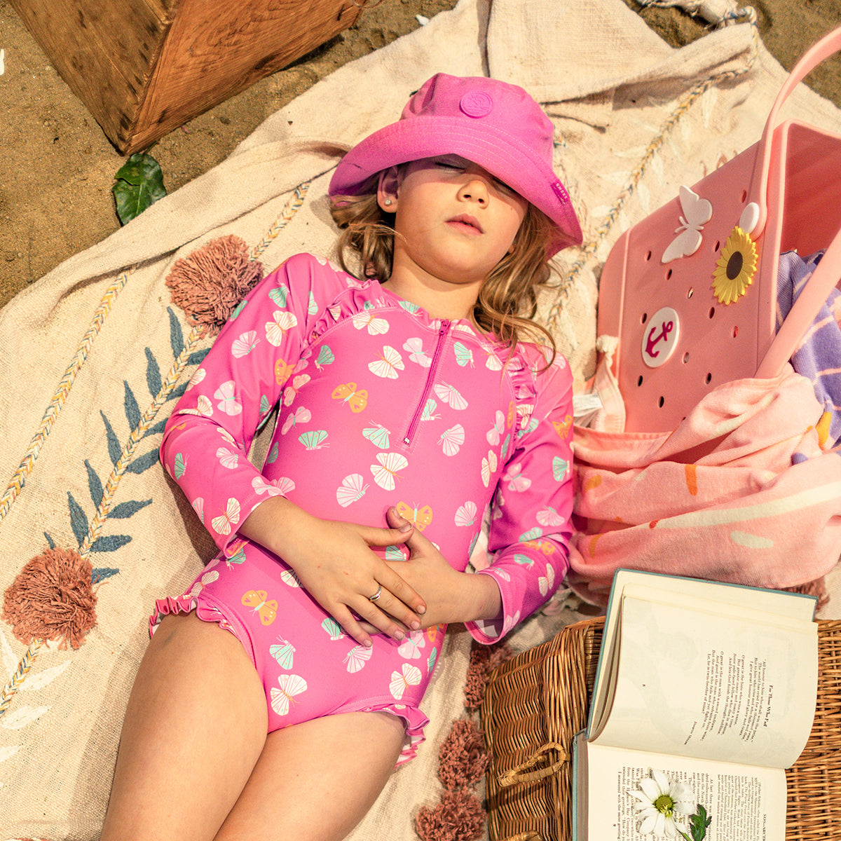 Pink one-piece swimsuit with butterfly pattern, child