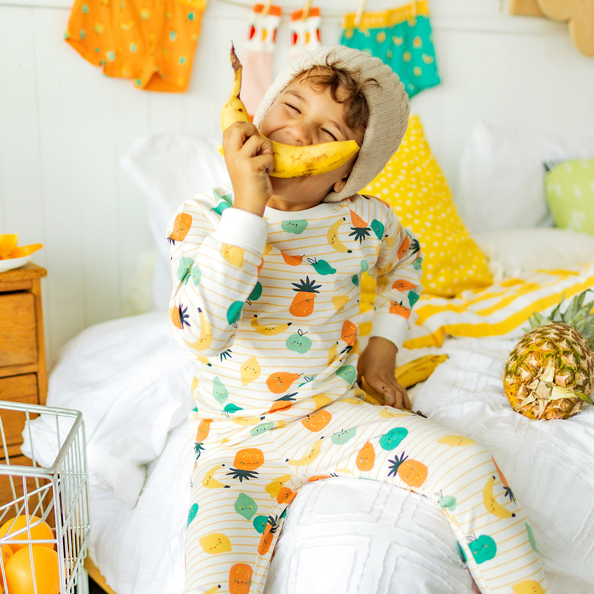 Two-piece cream pajamas with stripes and fruit patterns, child