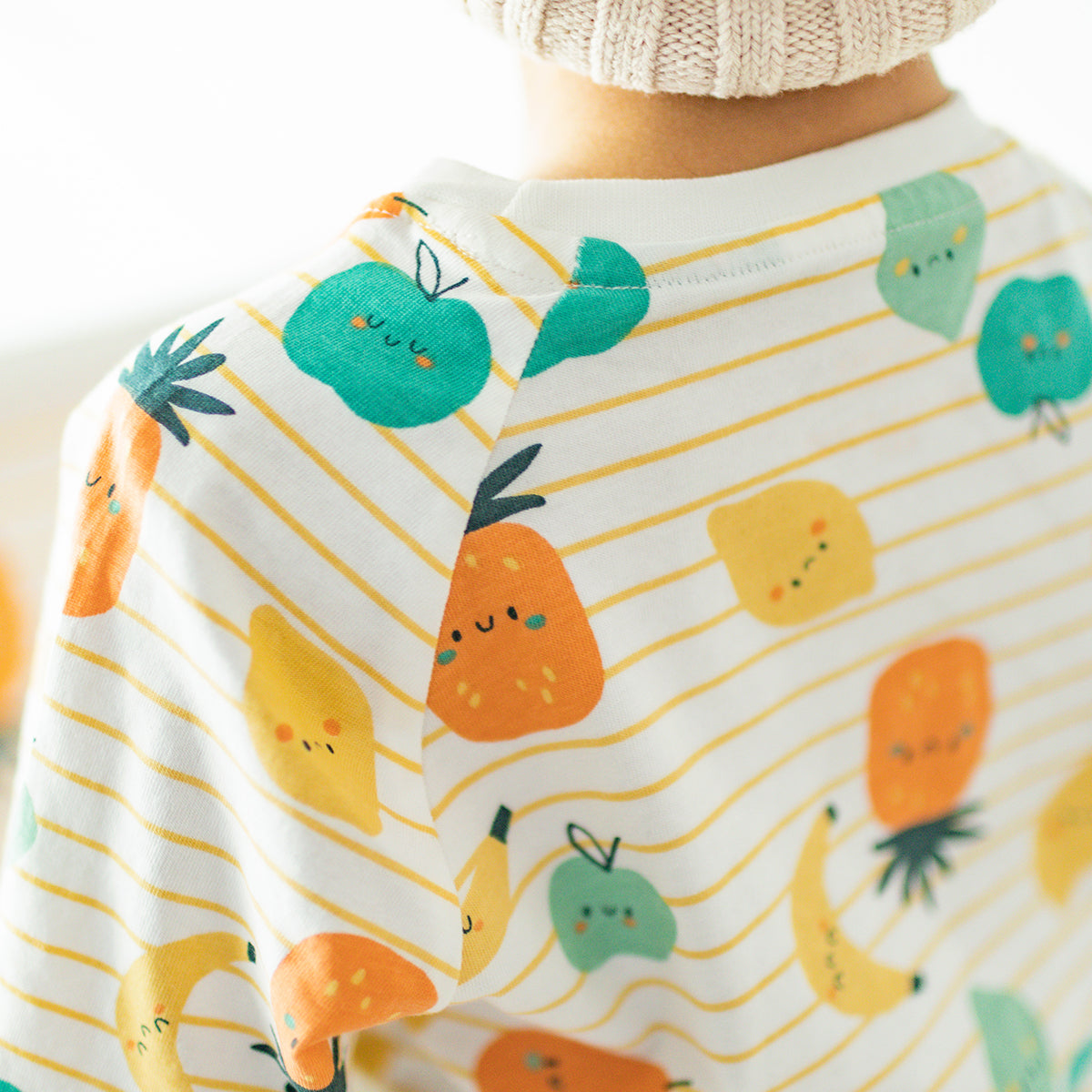 Two-piece cream pajamas with stripes and fruit patterns, child