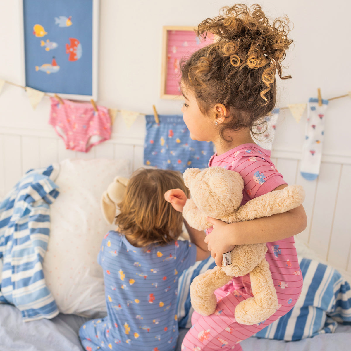 Pink one-piece pajamas with stripes and fish patterns, baby