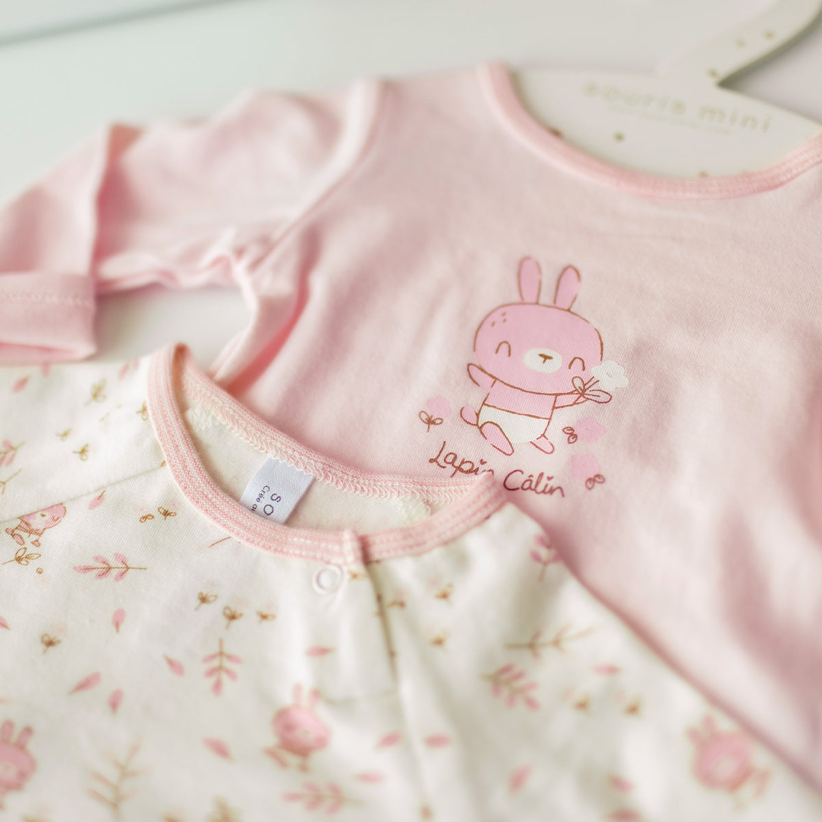 Set of two pink and cream bodysuits, newborn