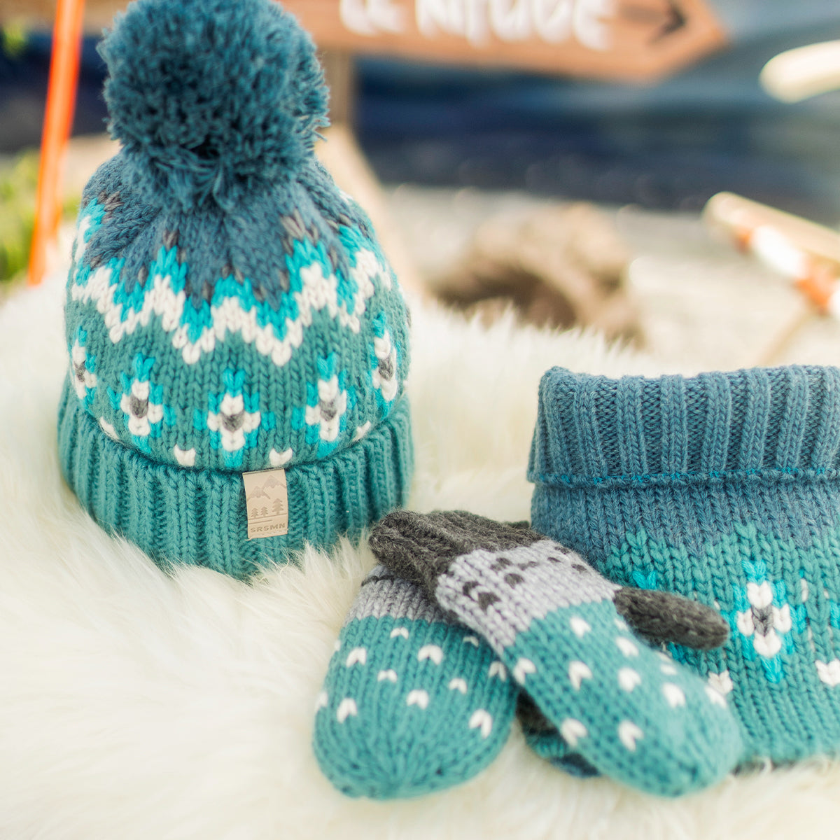 Présentation du cache-cou turquoise en tricot avec motifs, enfant