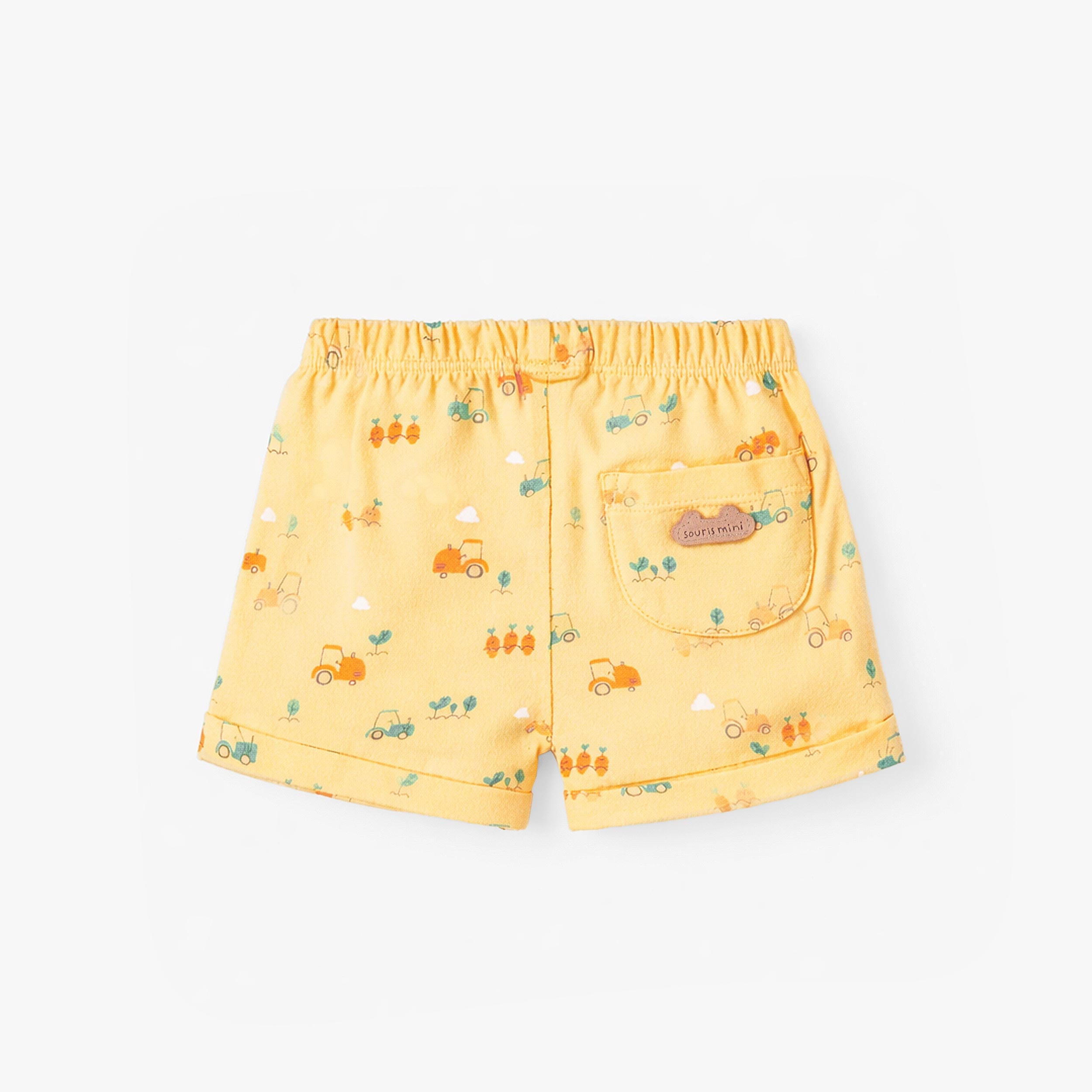 Dos du short jaune à motifs, naissance
