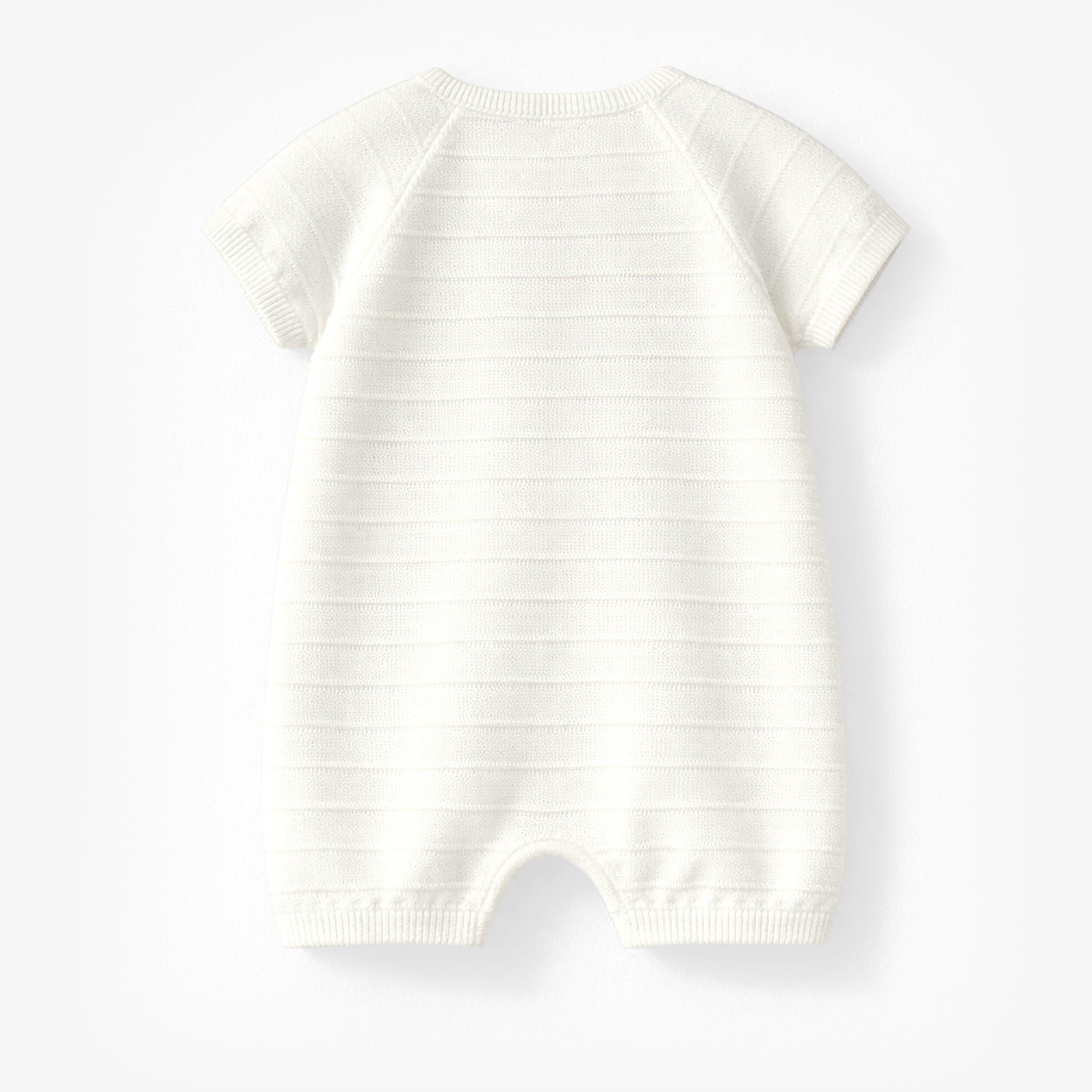 Dos de la barboteuse crème en tricot avec rayures, naissance