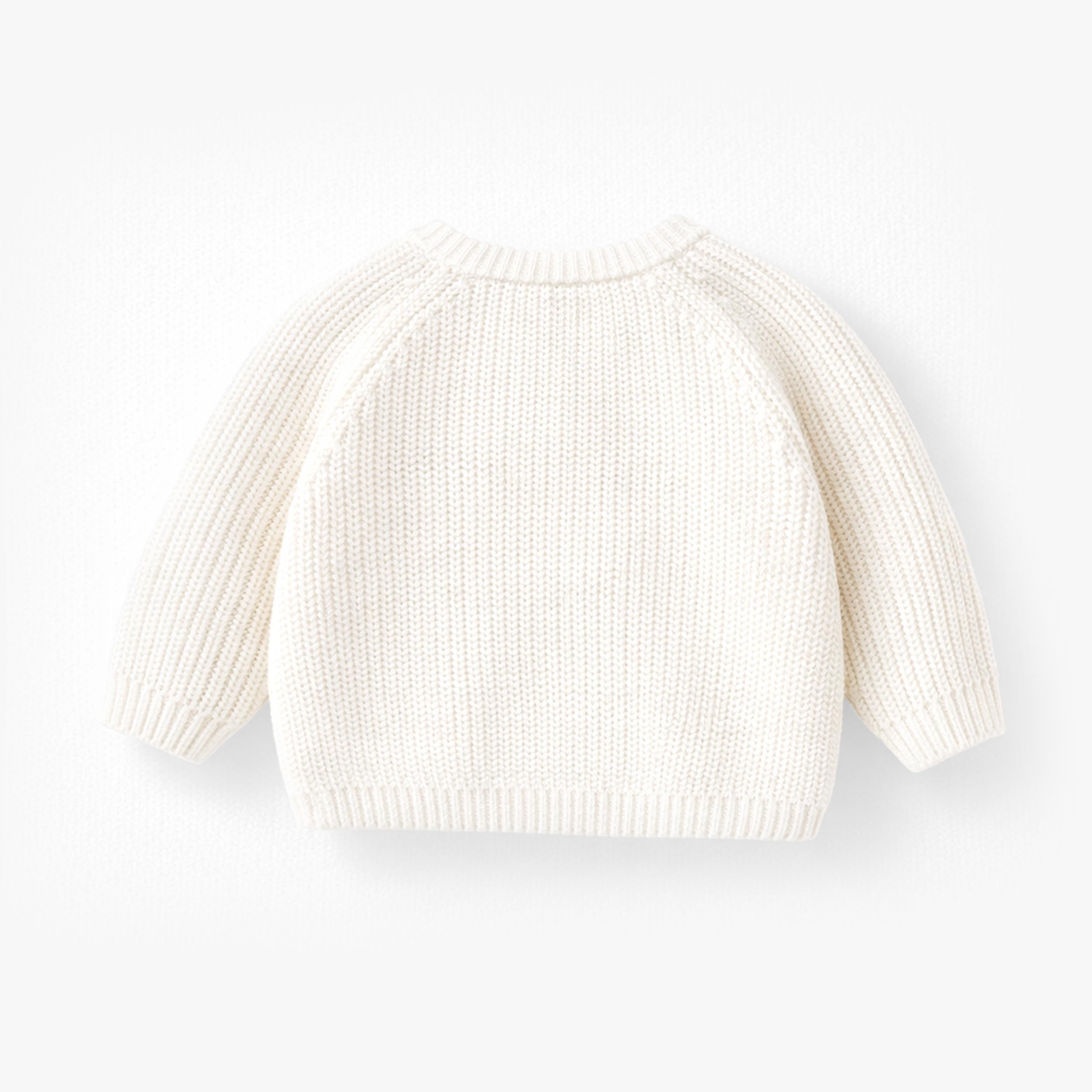 Dos du chandail crème en tricot avec arrosoir, naissance