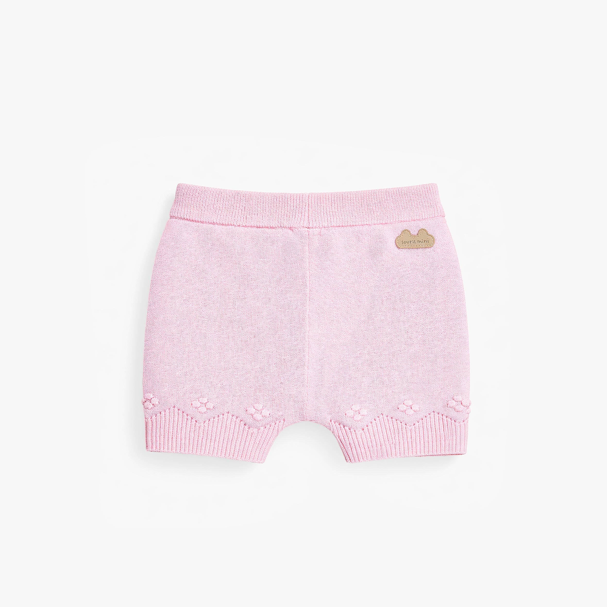 Dos du short rose en tricot à motif pointelle, naissance