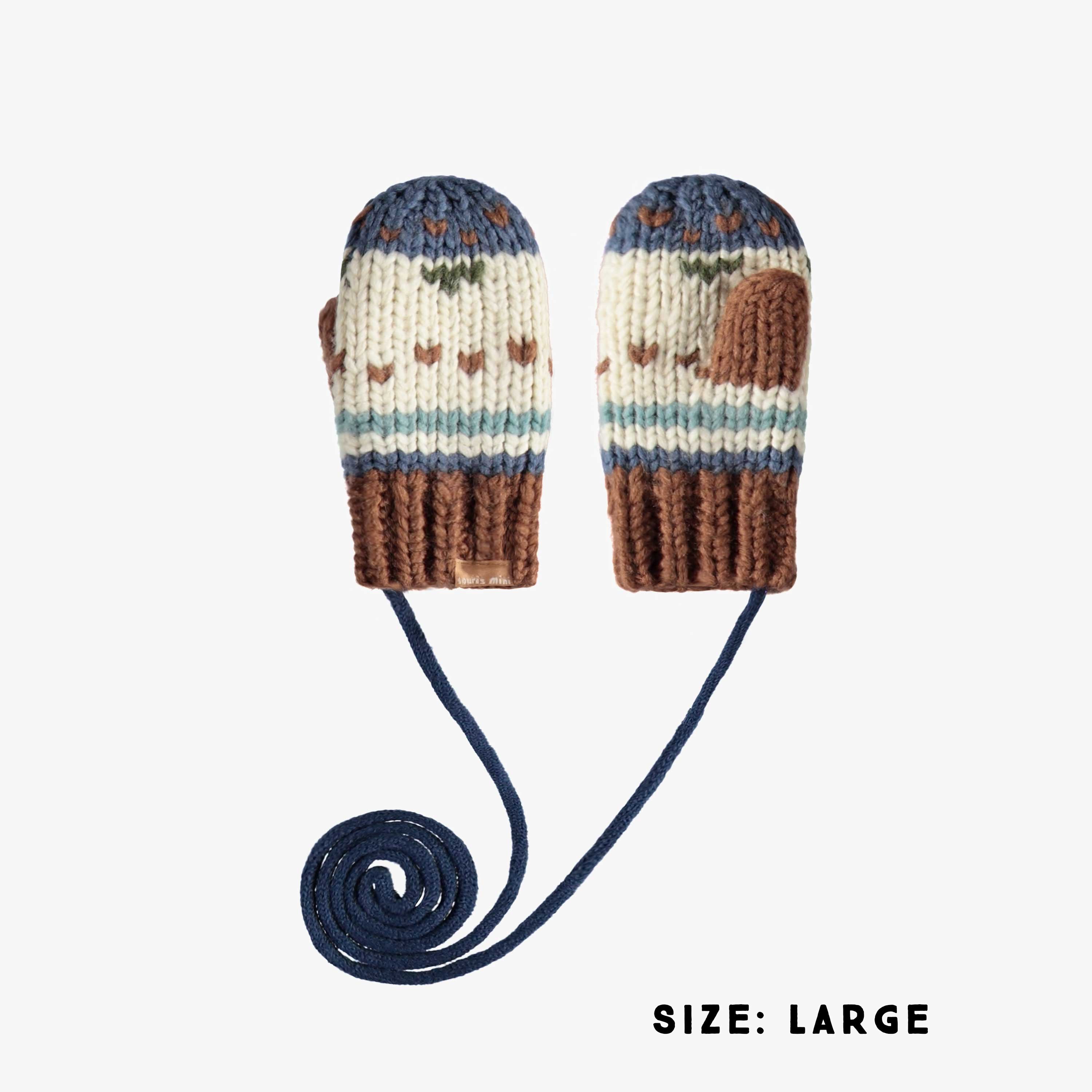 Cream and navy knitted mittens with a jacquard print and a cord, baby
