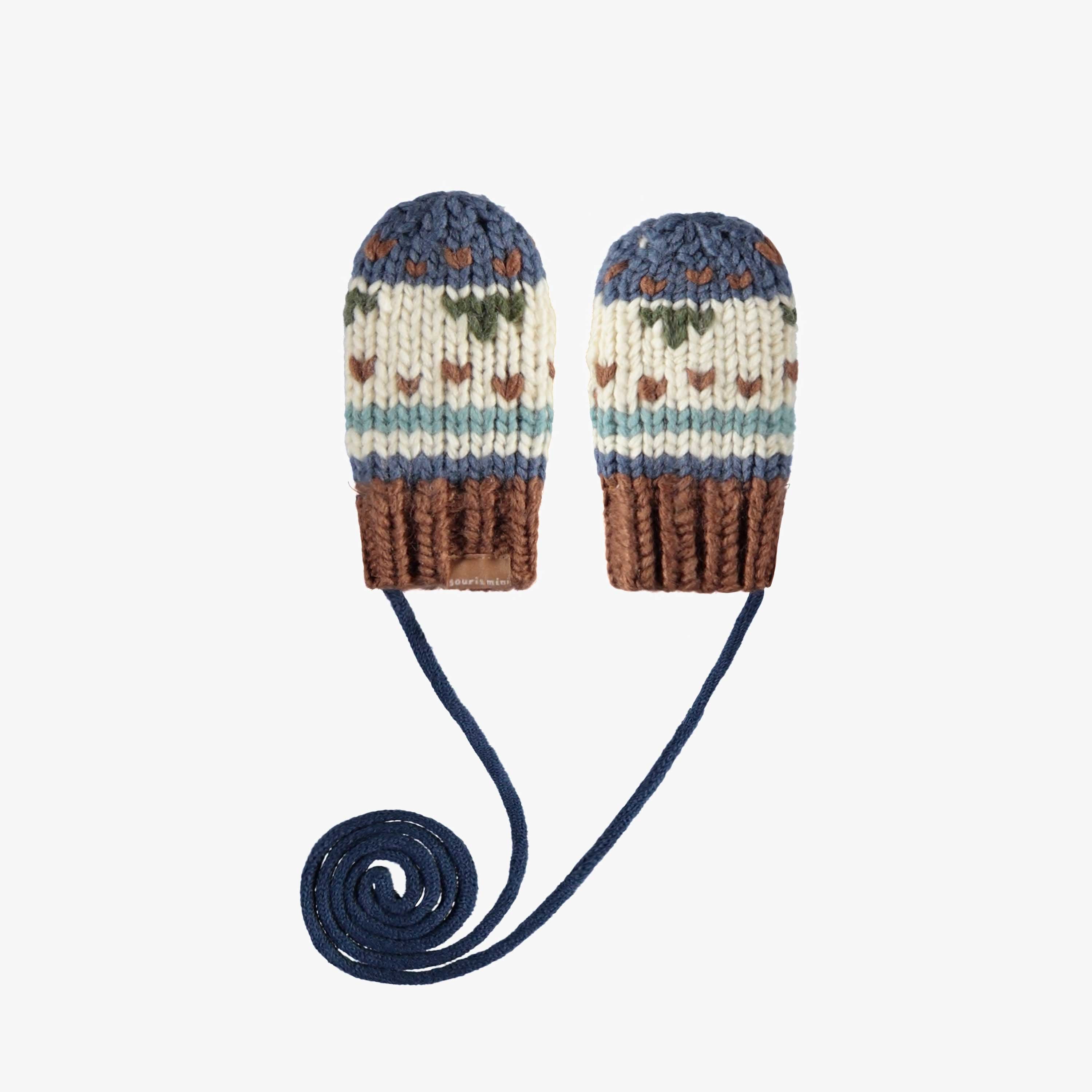 Cream and navy knitted mittens with a jacquard print and a cord, baby