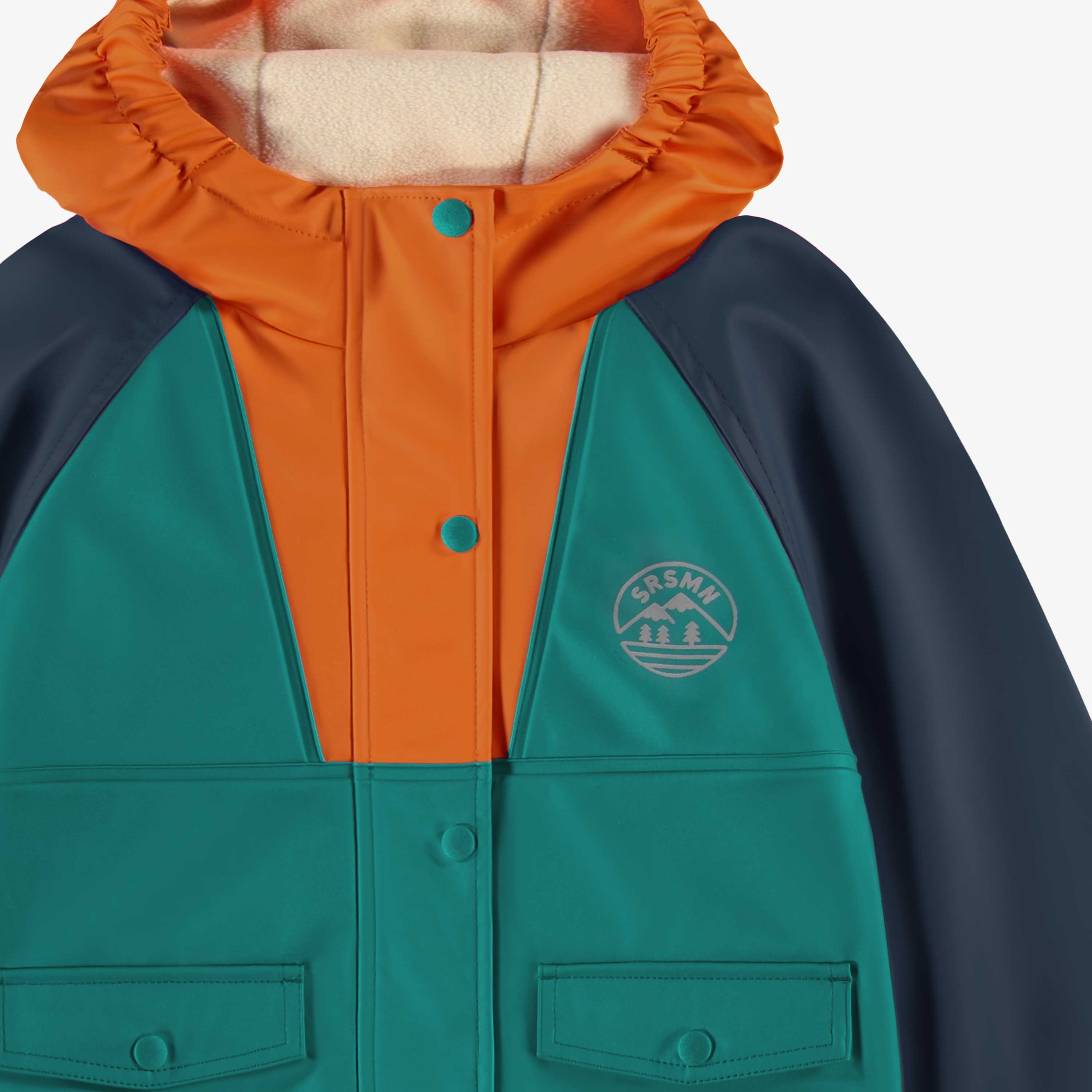 Zoom détails du manteau imperméable bleu, turquoise et orange, enfant
