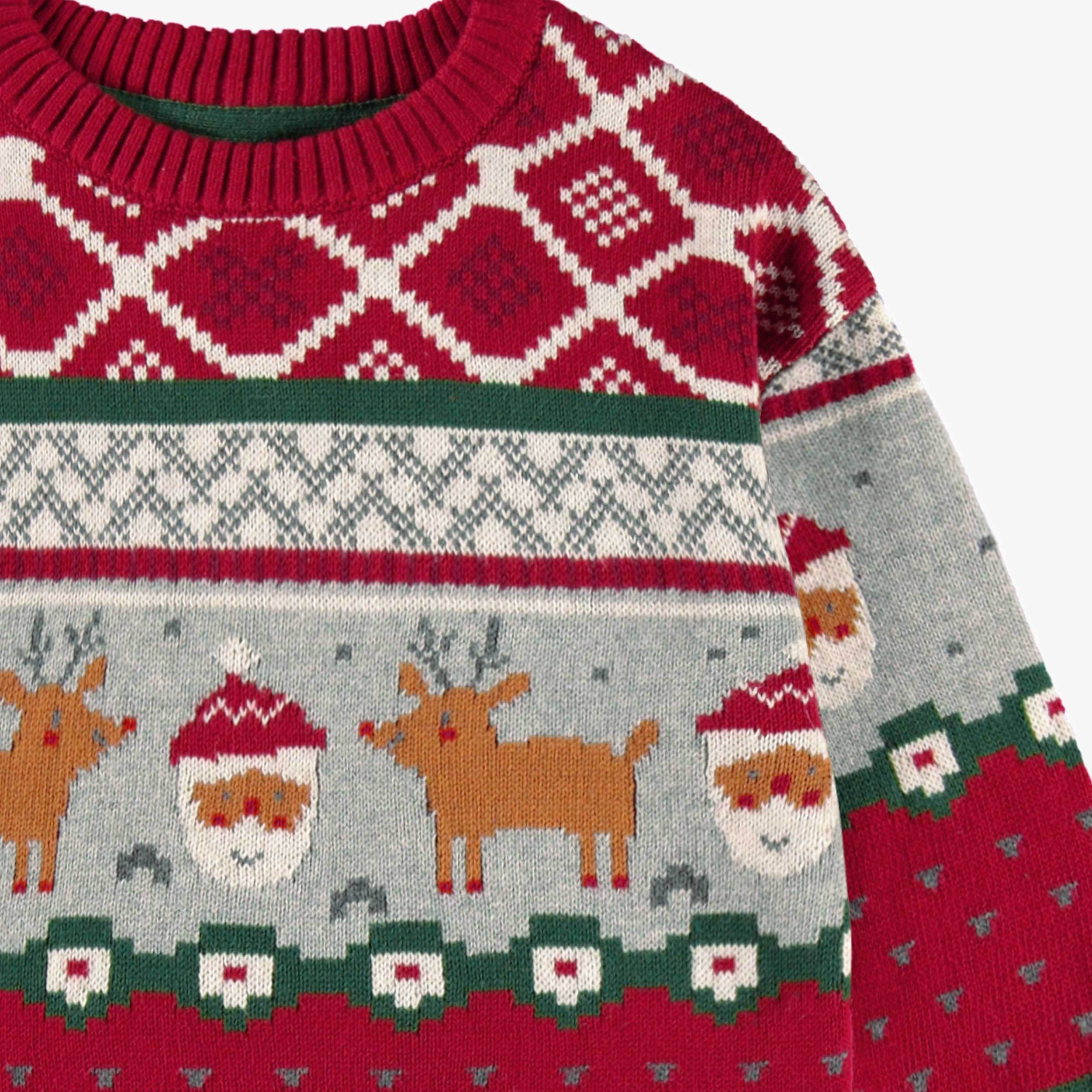 Red knit sweater with festive patterns, child