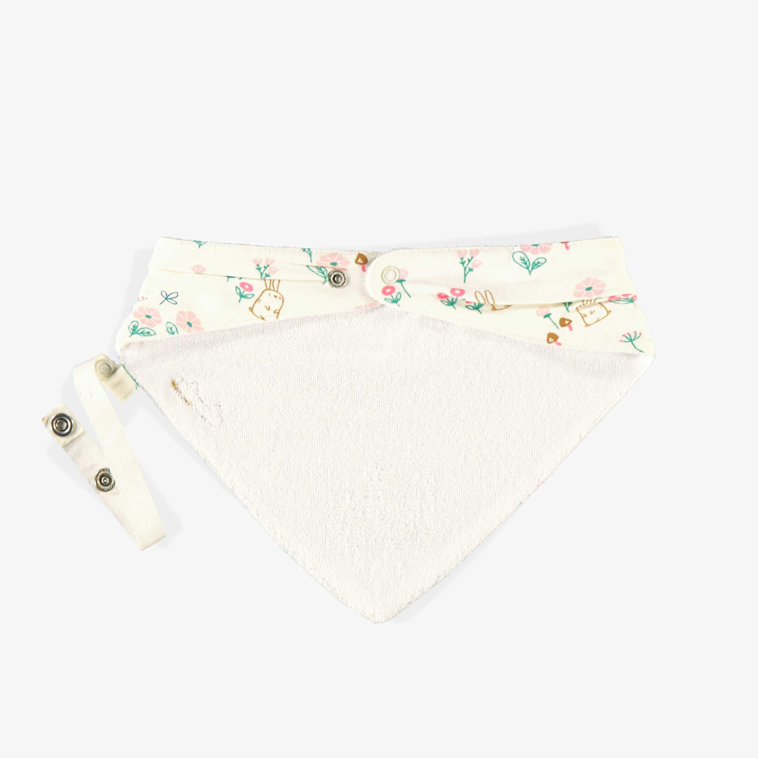 Bavoir crème à motifs, naissance