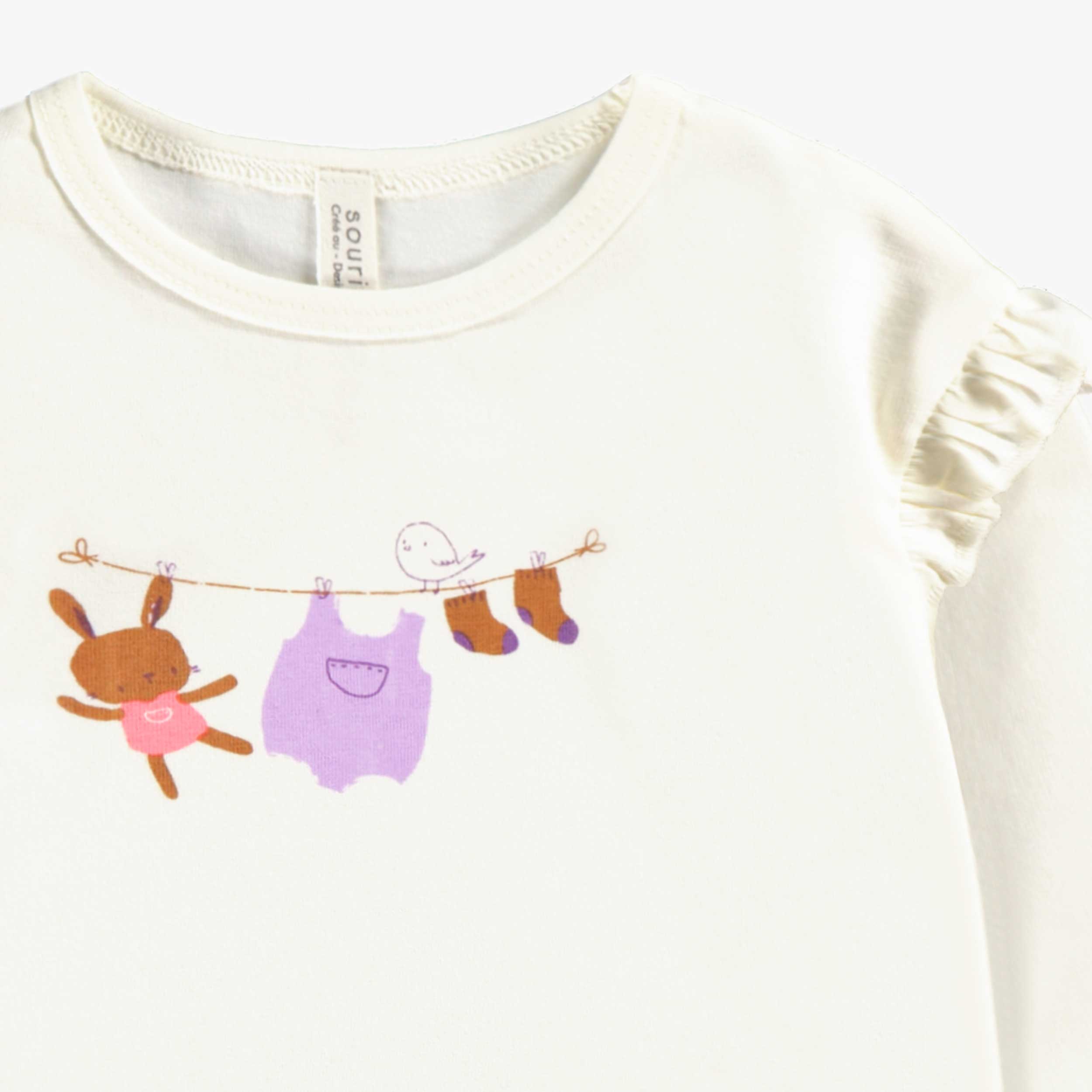 Zoom illustration du t-shirt crème avec illustration, naissance