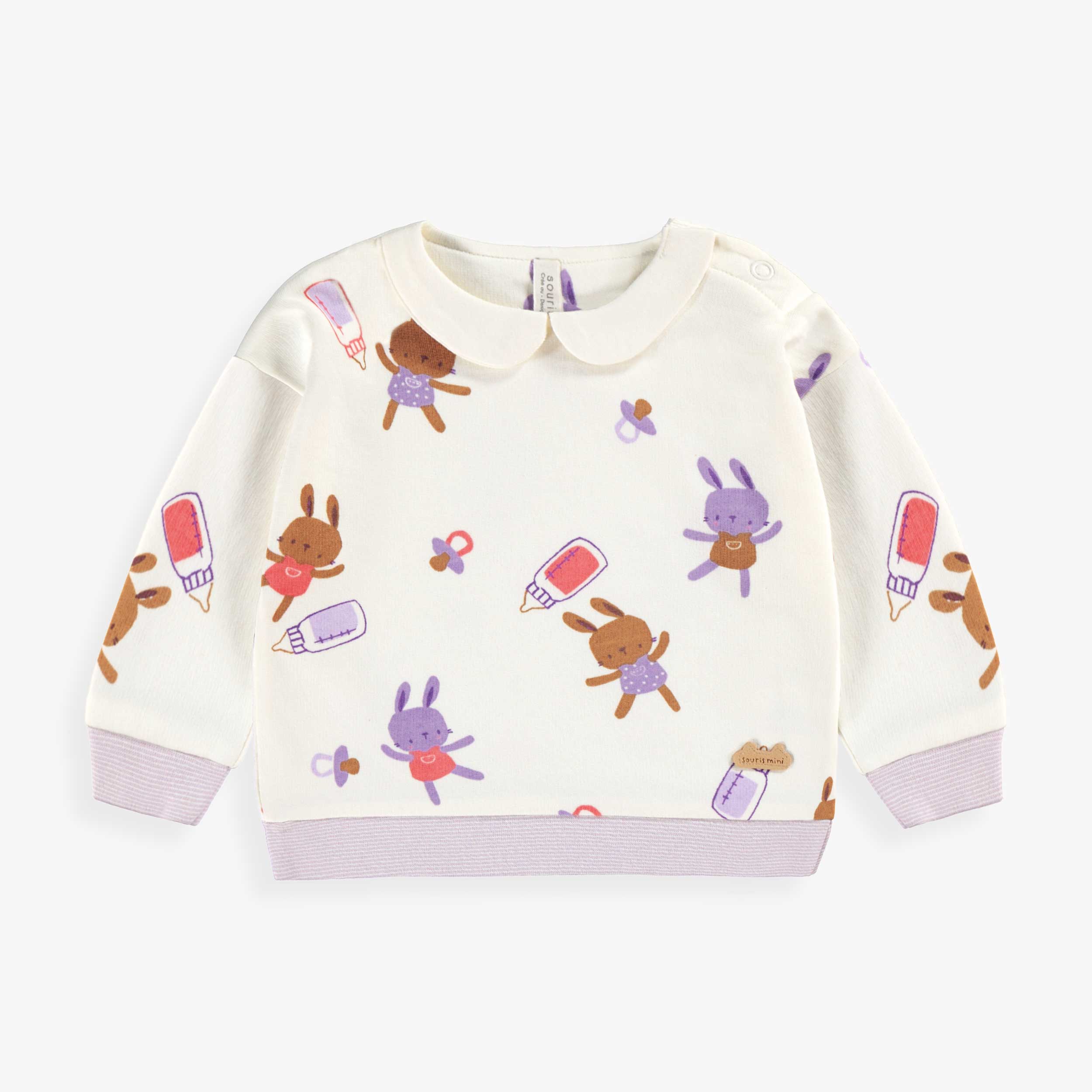 Chandail crème à motifs, naissance