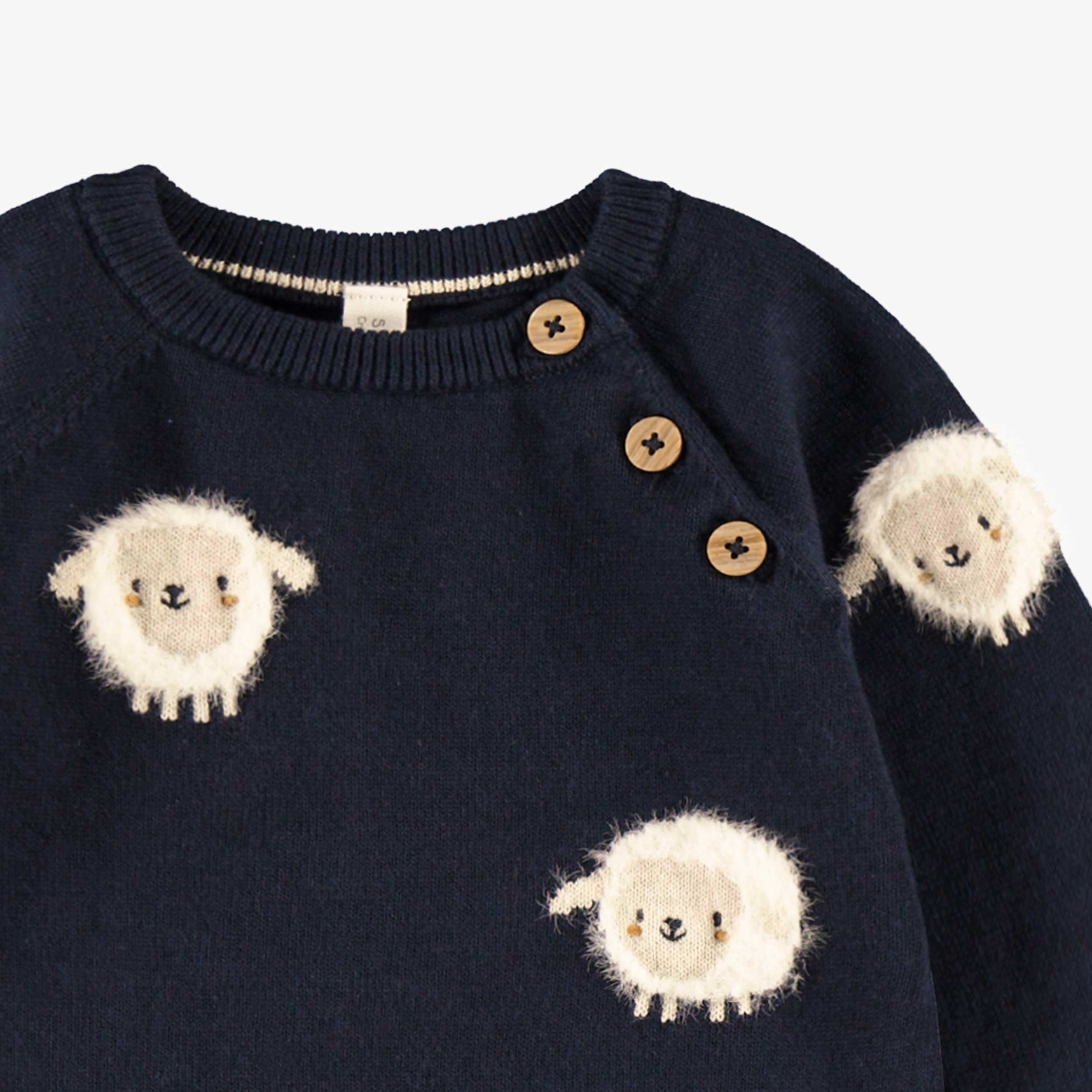 Zoom imprimés moutons de l'une pièce bleu marine en tricot, naissance