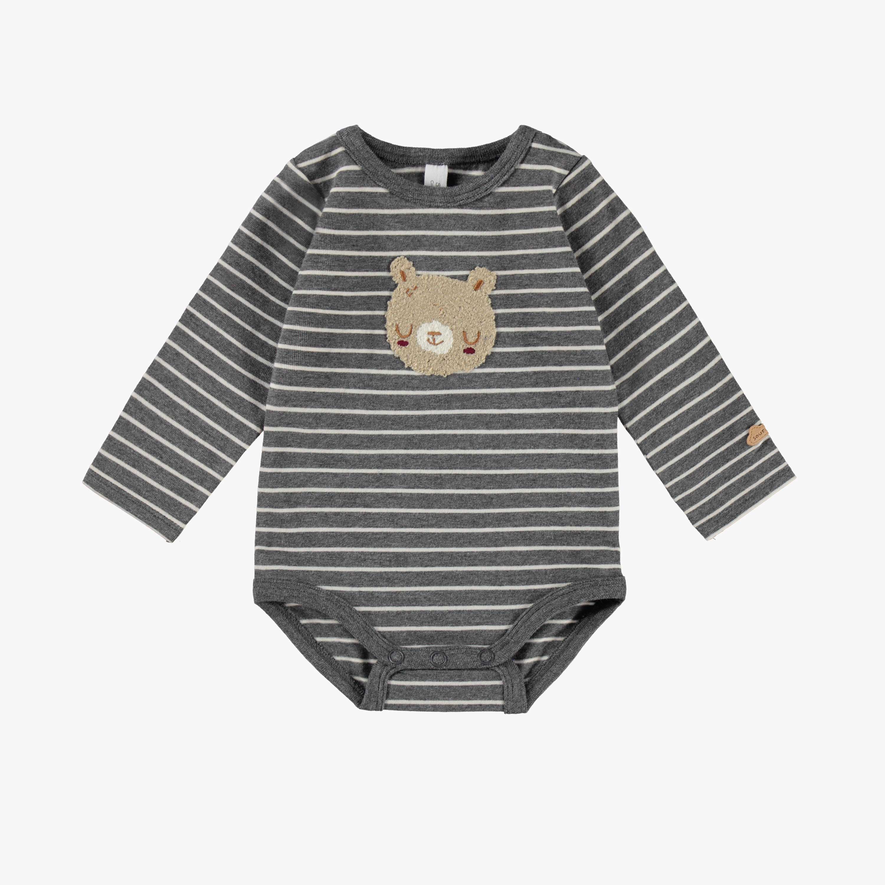 Cache-couche gris à rayures, naissance