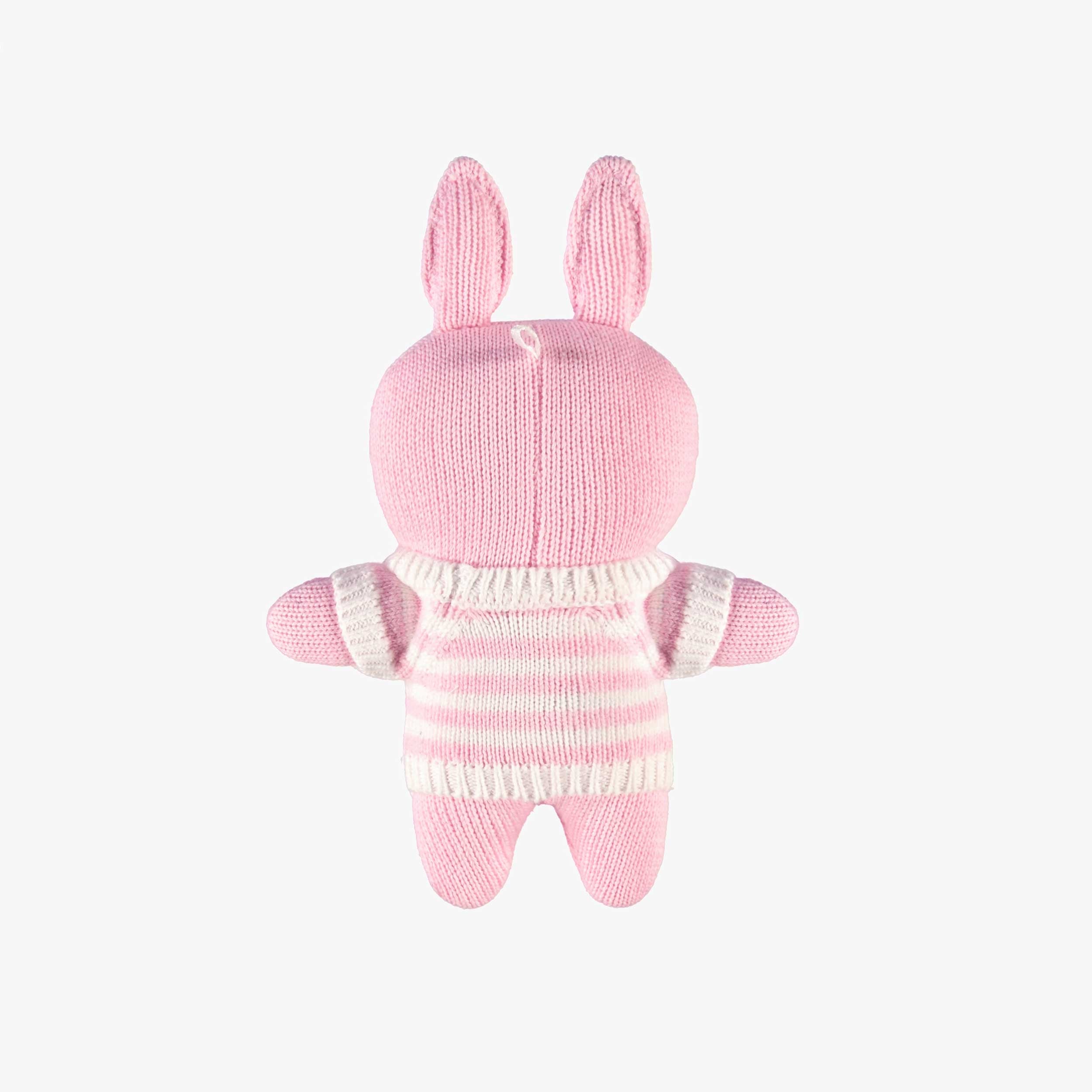 Dos de la peluche rose en tricot, naissance