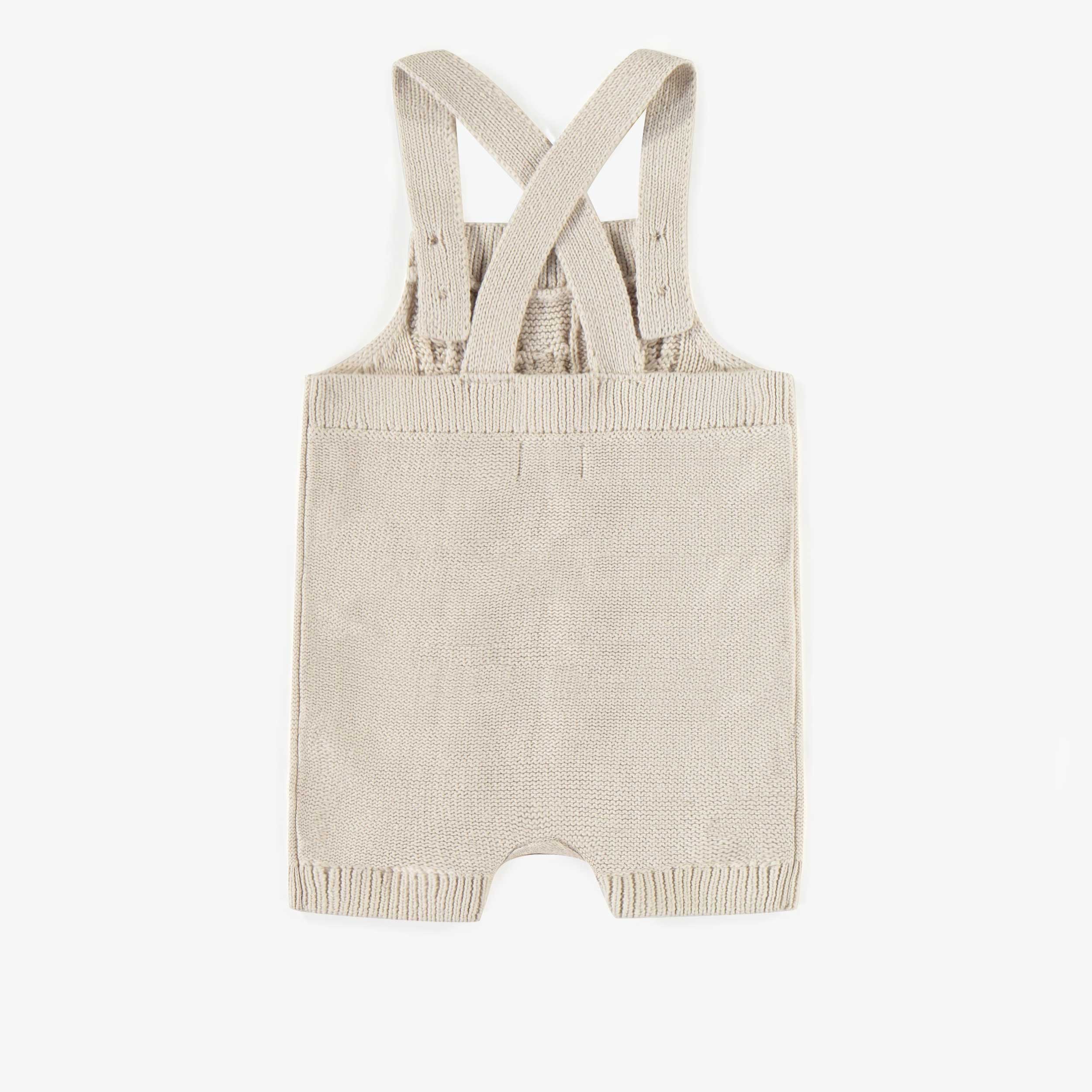 Dos du une-pièce crème en maille, bébé