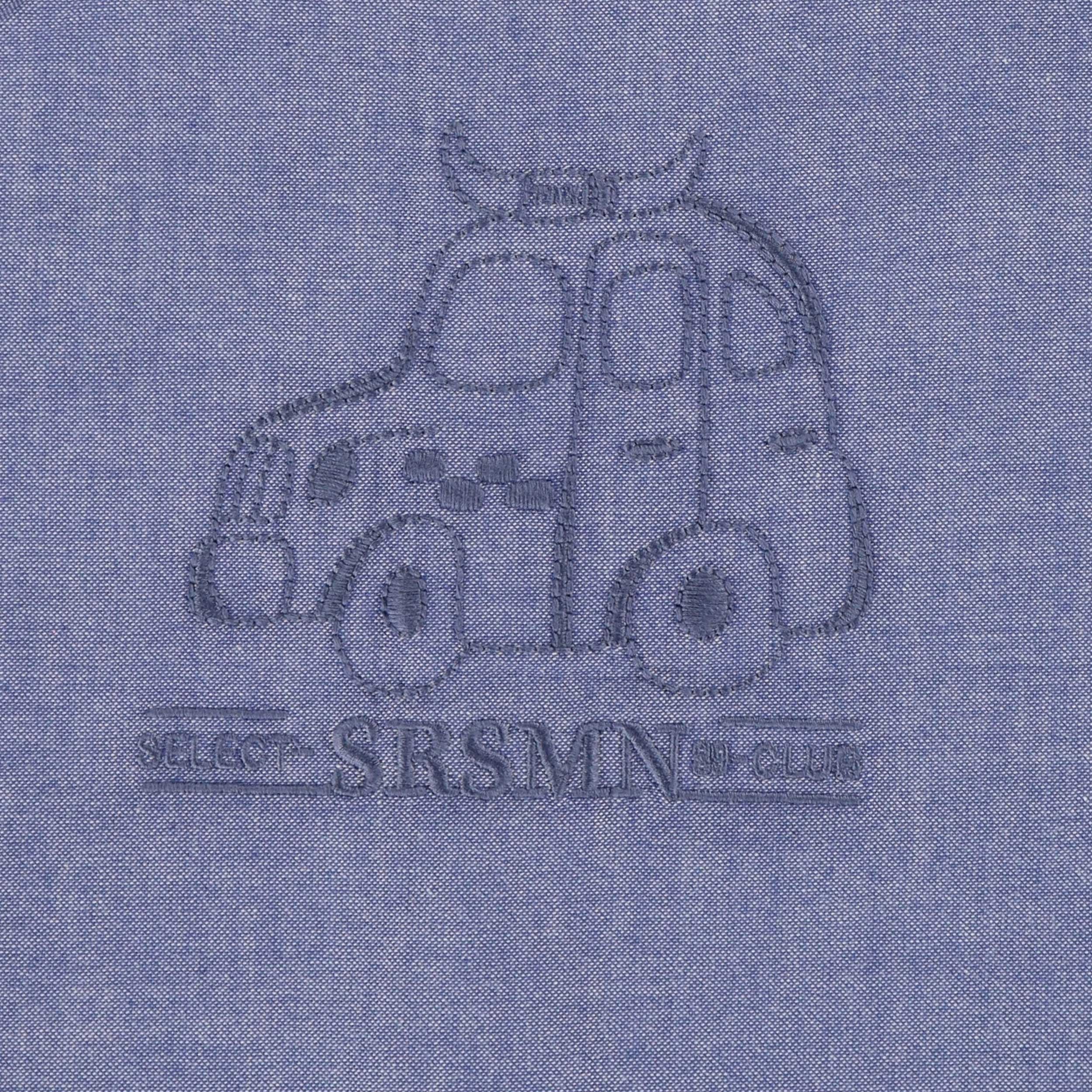 Détail de la chemise bleu chiné en coton chambray, bébé