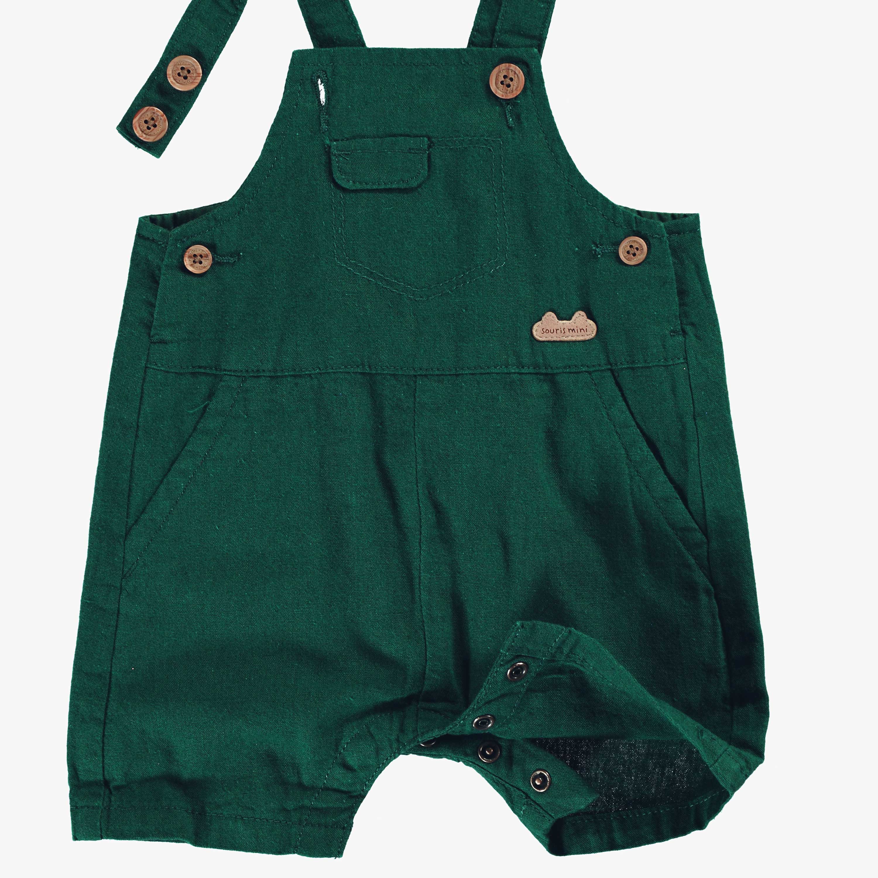 Détail de la salopette verte avec bretelles ajustables, naissance