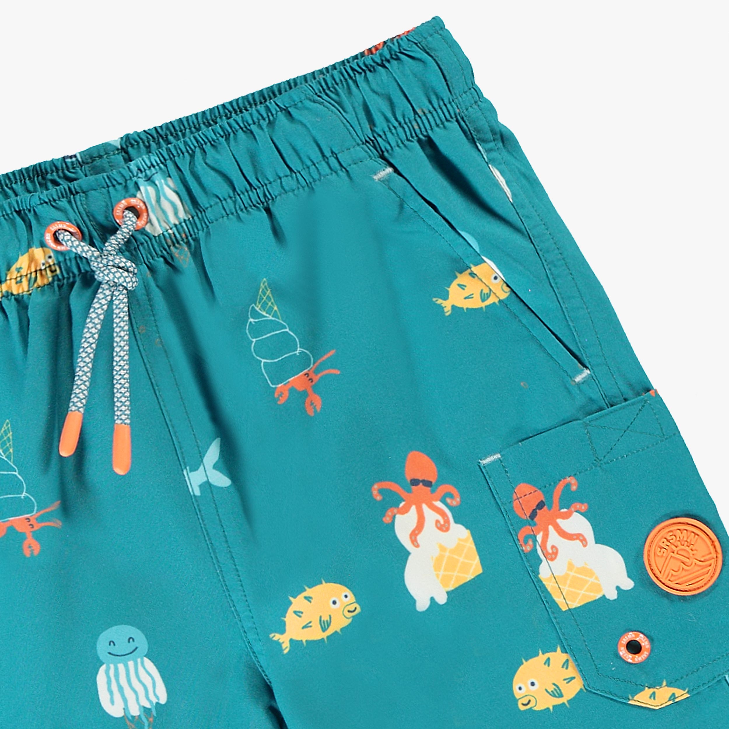 Zoom détails du bermuda de bain bleu sarcelle avec motifs, enfant