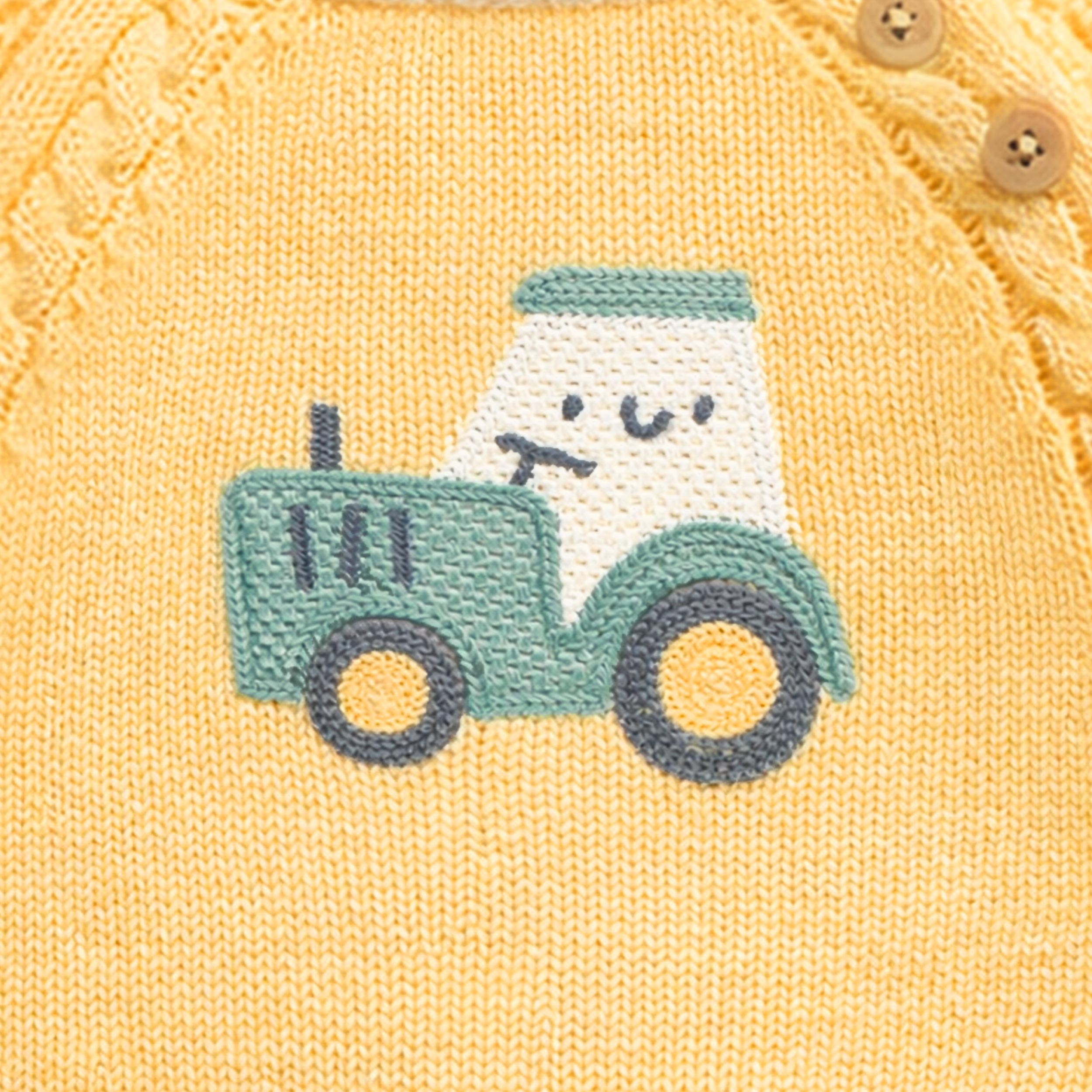 Zoom détails du chandail jaune en tricot avec tracteur, naissance
