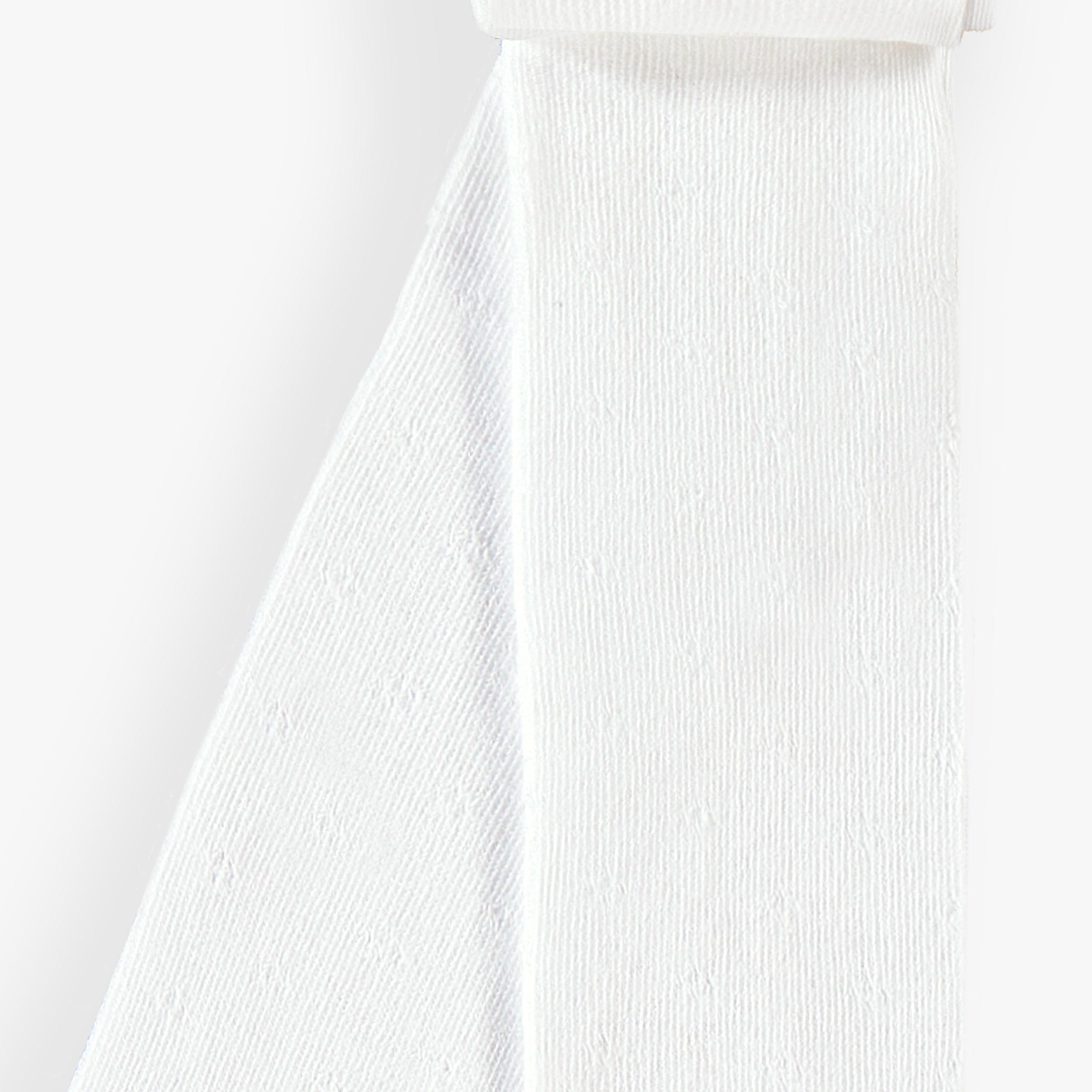 Zoom détails du collant blanc avec motif pointelle, enfant