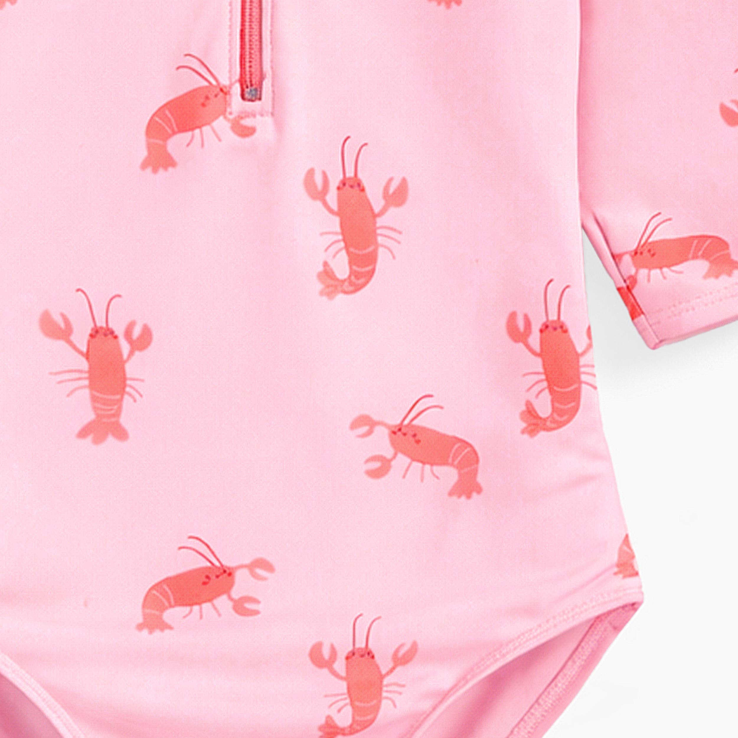 Zoom détails du maillot de bain une pièce rose à motifs de homards, enfant