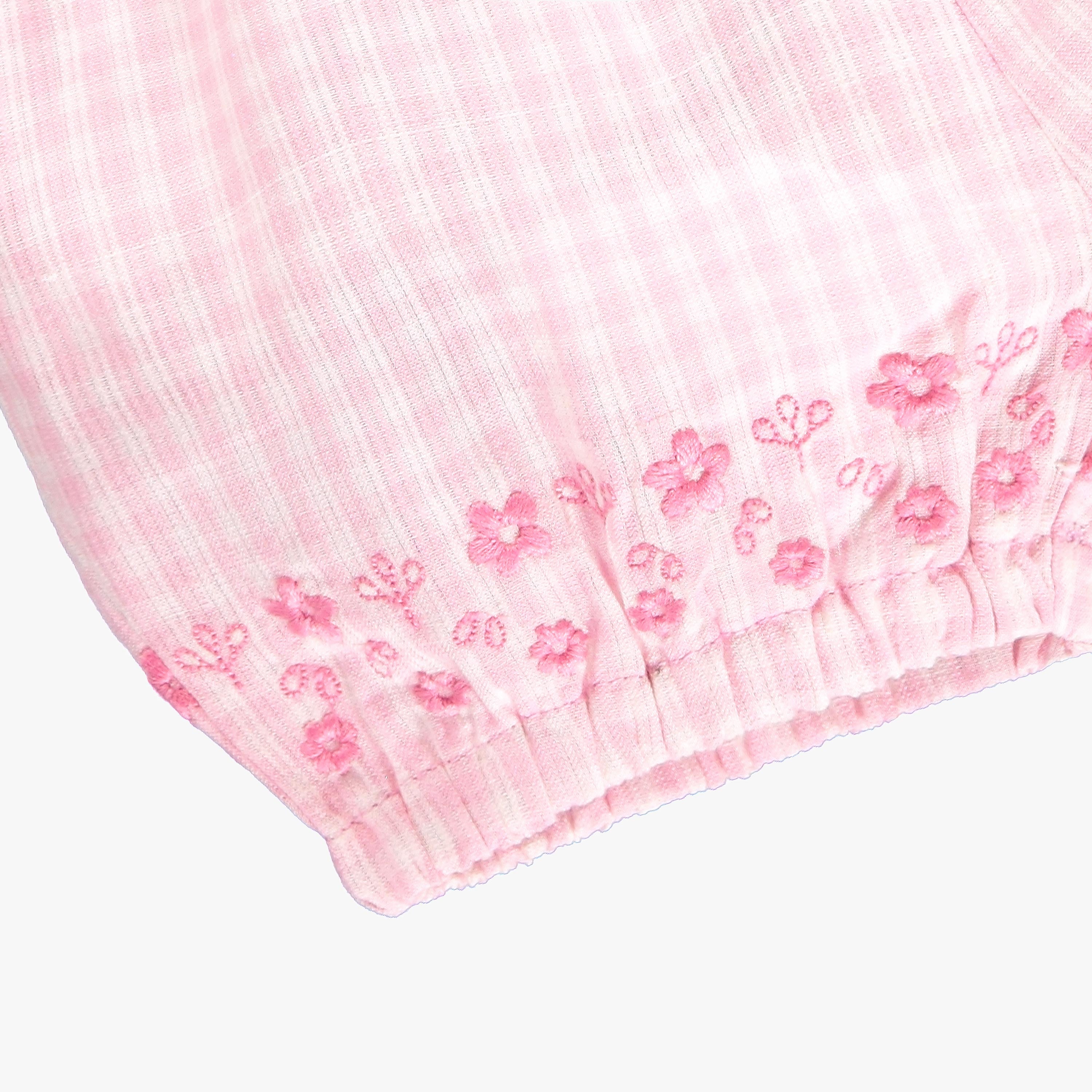 Zoom détails bas du short rose à carreaux et broderie anglaise, naissance